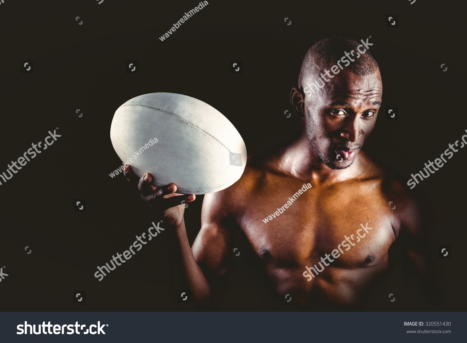 Portrait Confident Shirtless Sportsman Holding Rugby Stock Photo