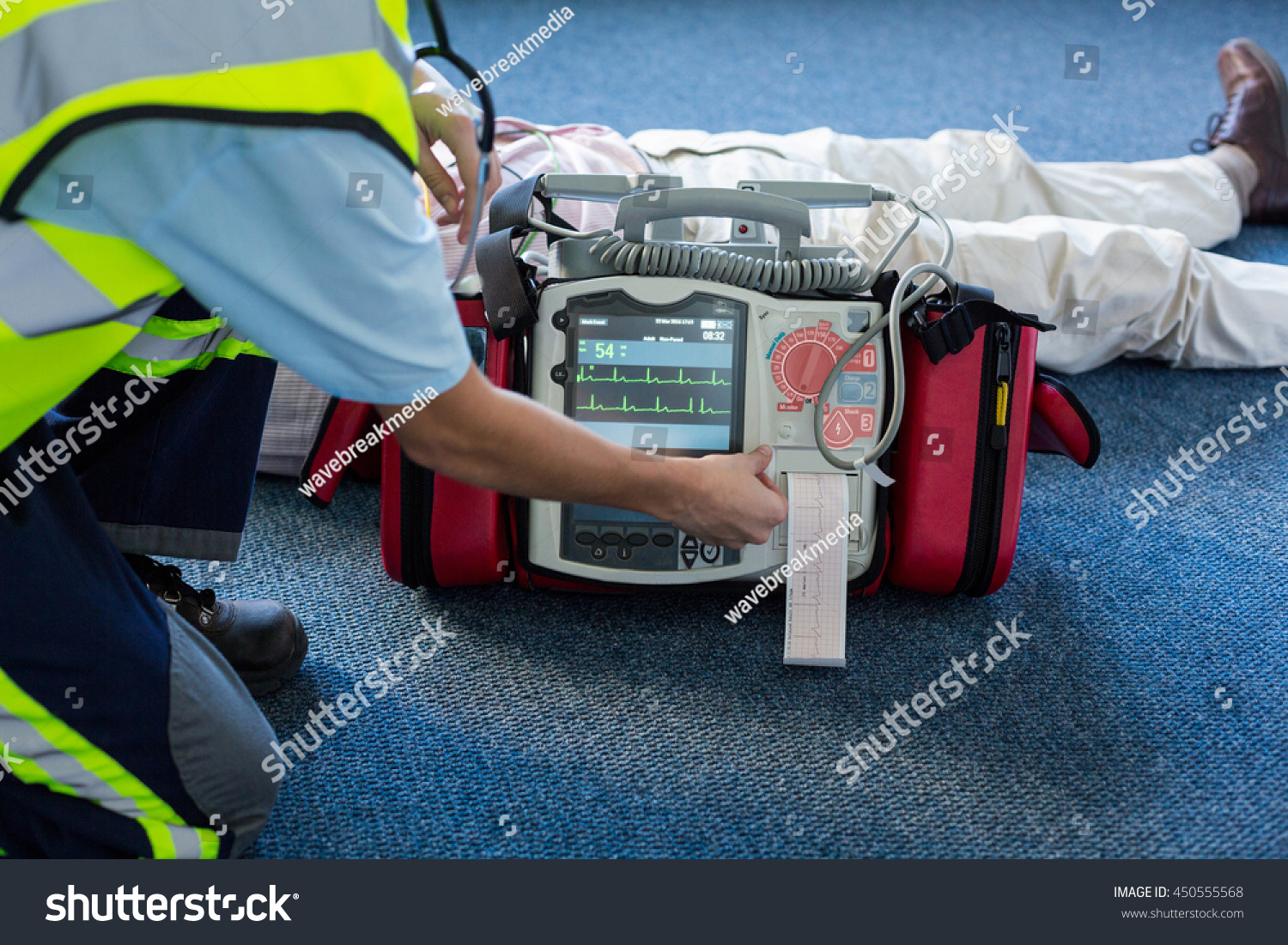 Paramedic Using External Defibrillator During Cardiopulmonary Stock