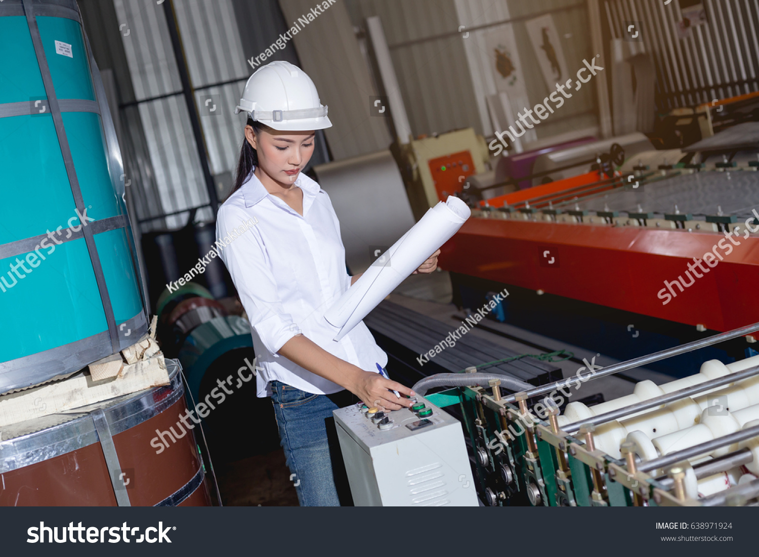 Asian Woman Engineer Working On Machine Stock Photo 638971924