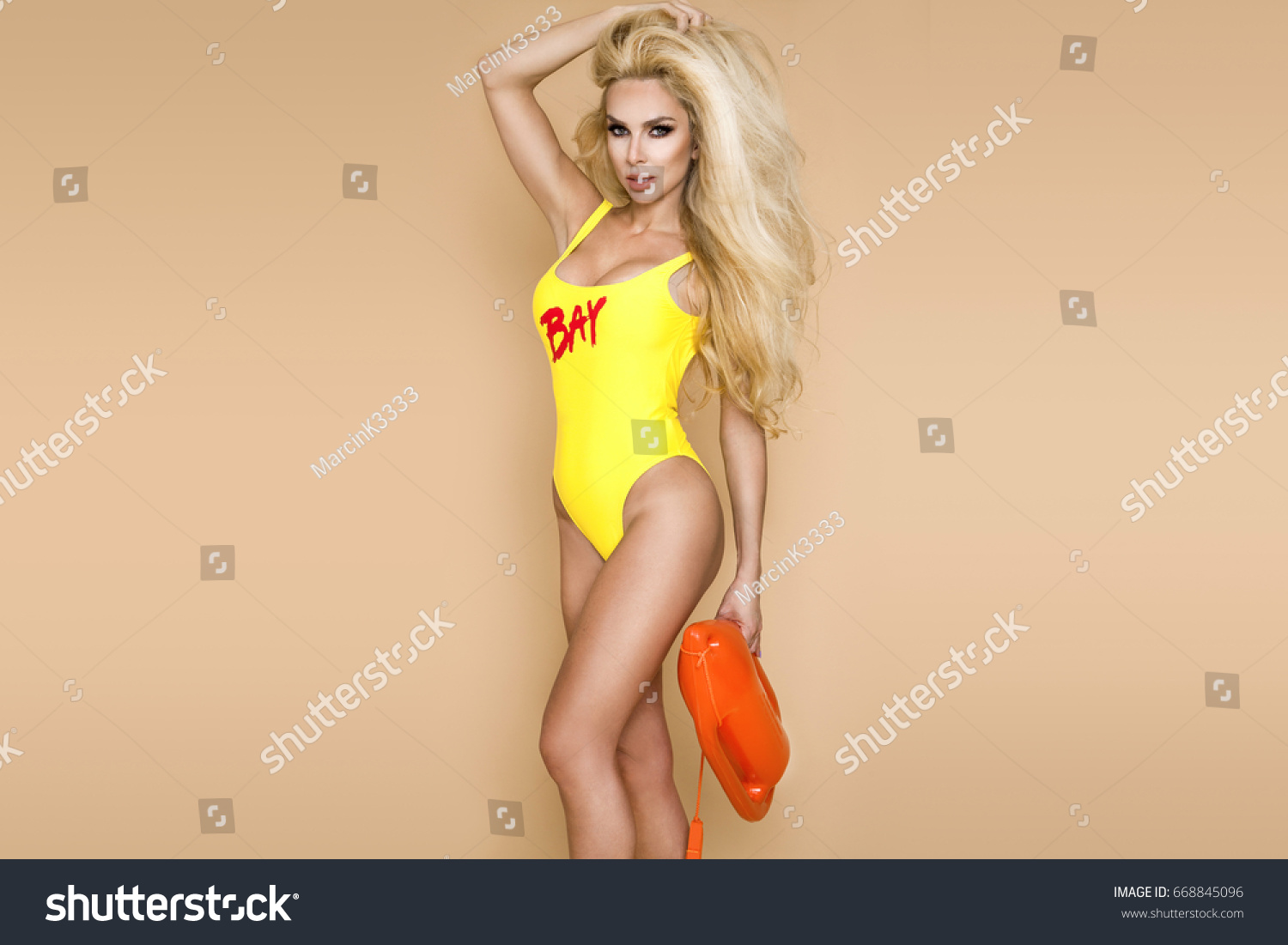 Sexy Busty Lifeguard Woman Bikini Holding Stock Photo 668845096