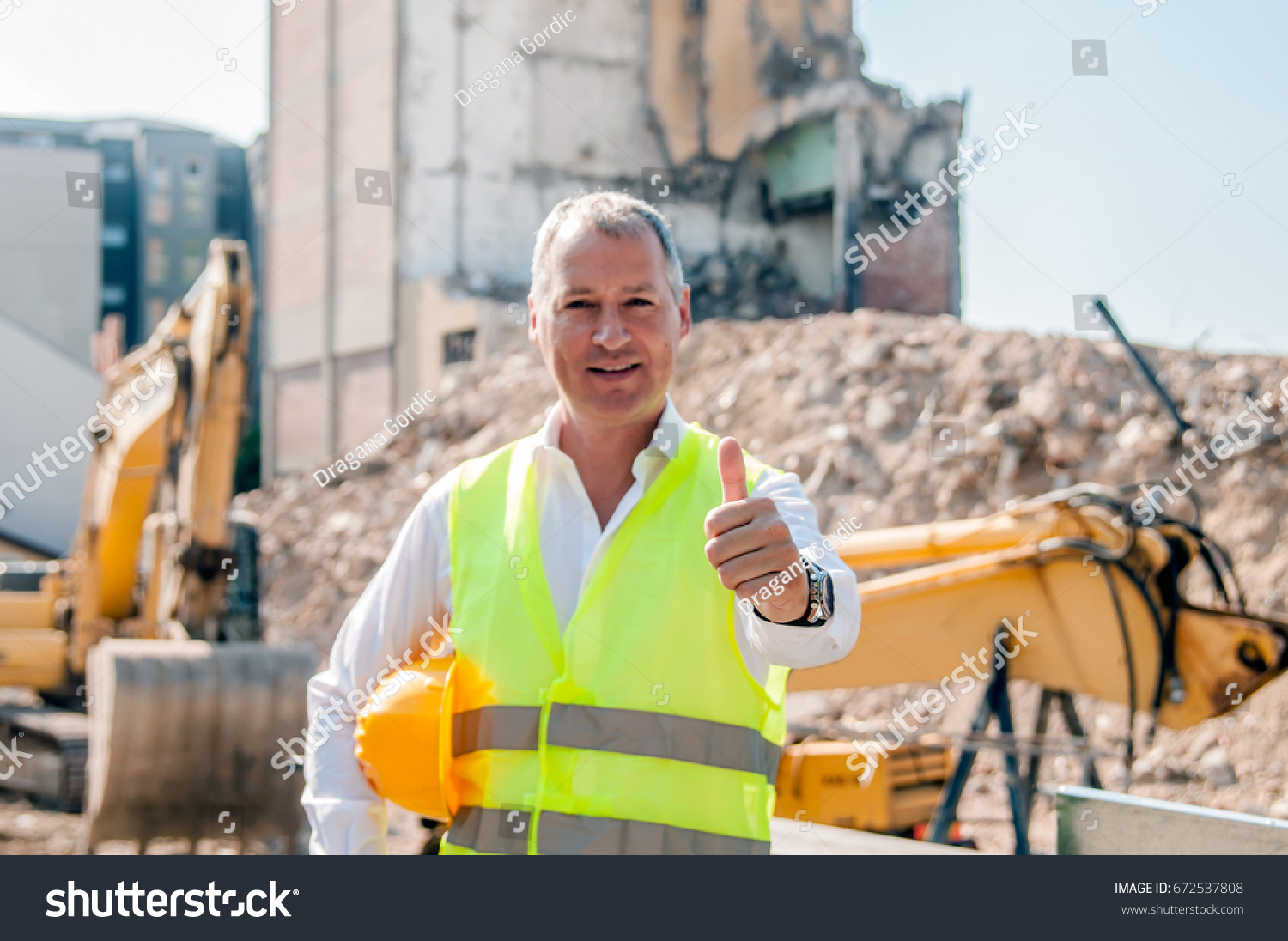 Engineer Holding Safety Helmet Giving Thumbup Stock Photo