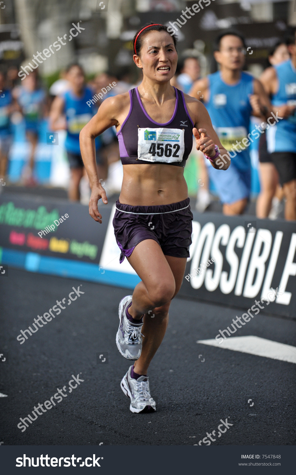 Chinese Female Athlete Completing Singapore Marathon Stock Photo