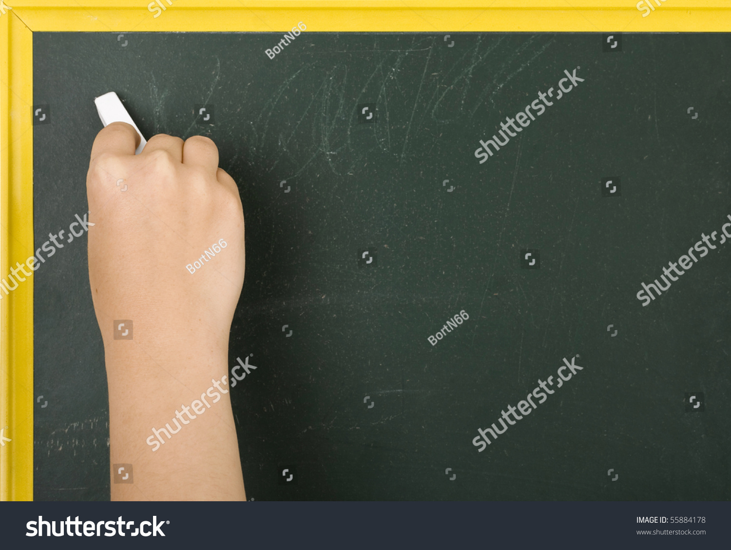 A Hand Holding Chalk About To Write Something On A Chalkboard Stock