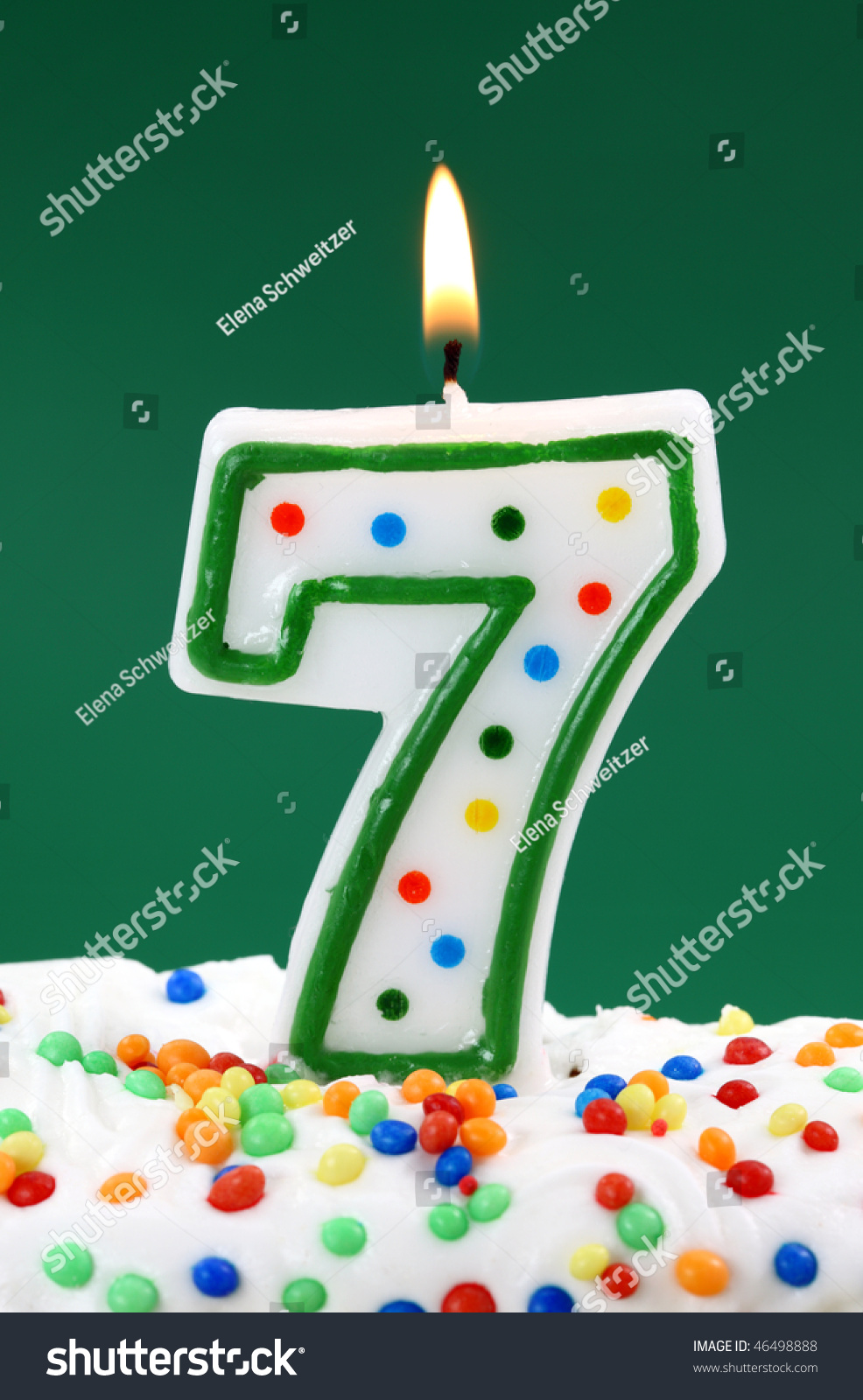 Number Seven Birthday Candle On Green Background Stock