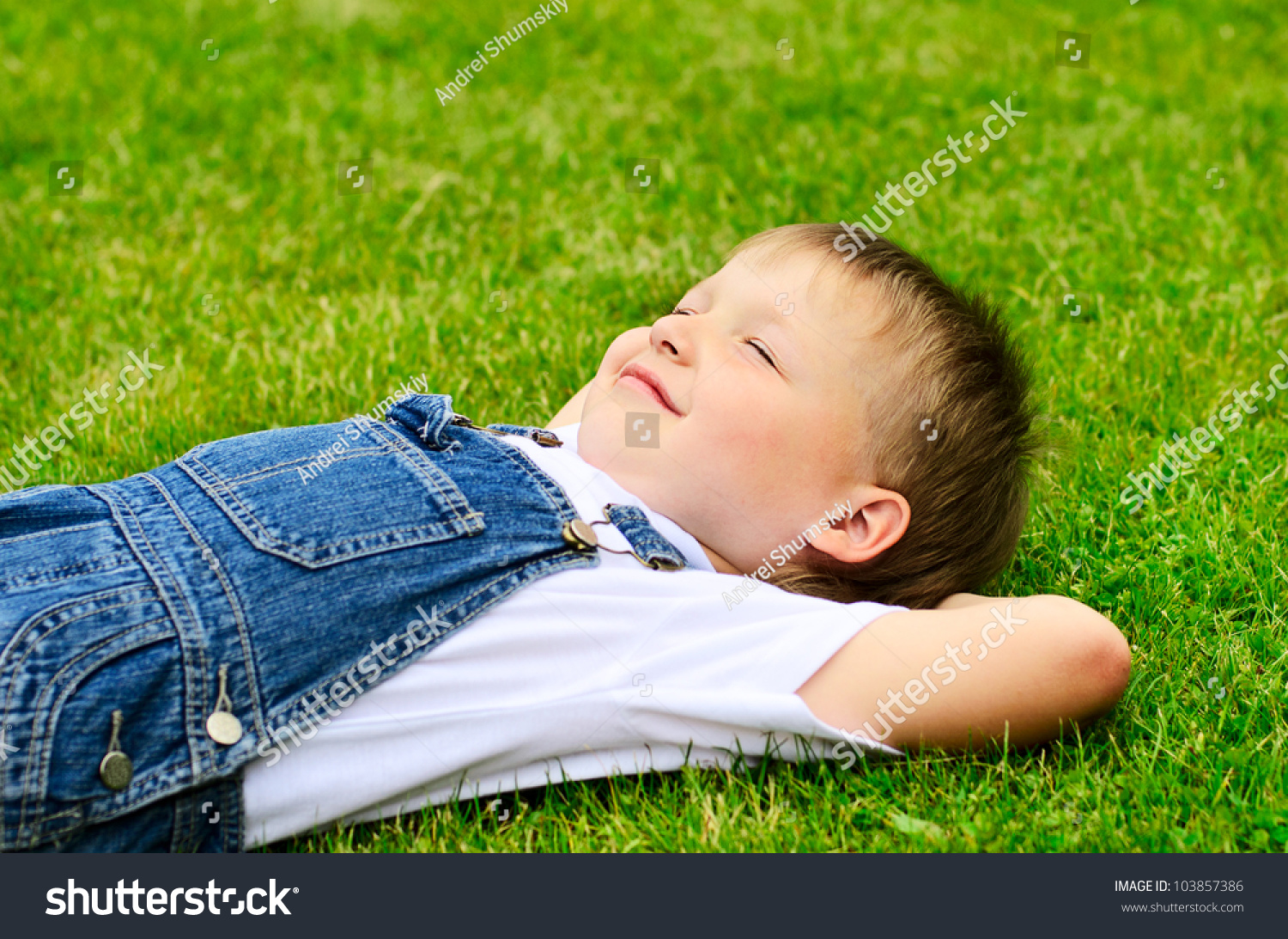 4 Years Old Child Lying On The Grass. Stock Photo ...