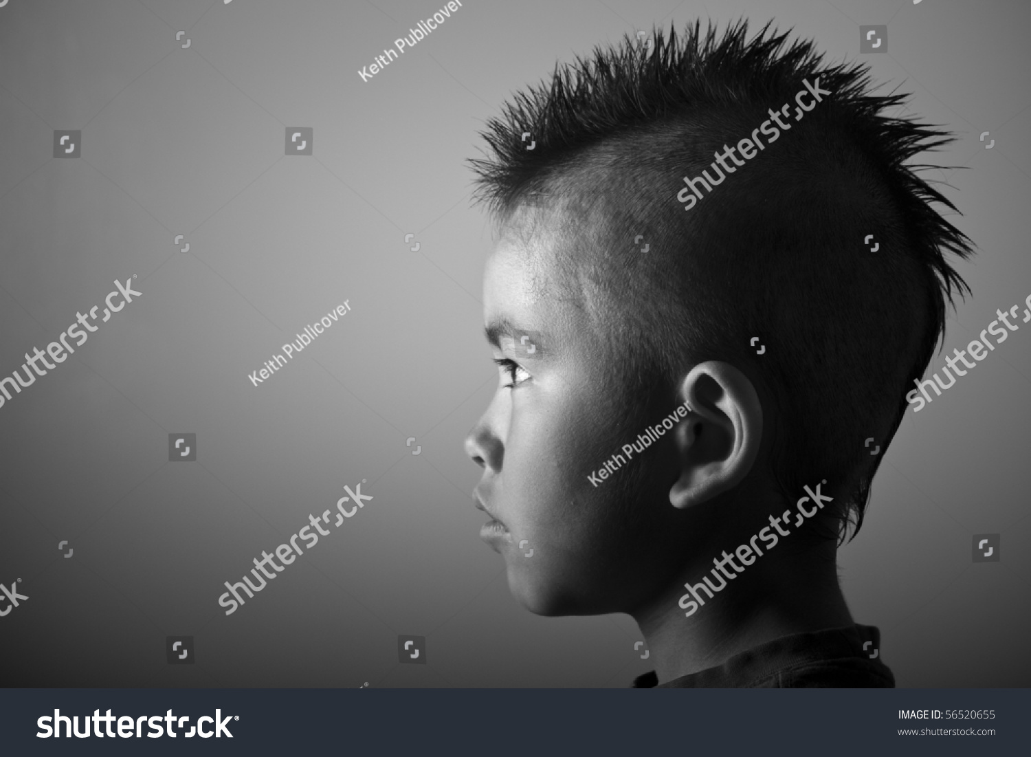 Young Boy With Funny Mohawk Haircut And Serious Look In Black And White