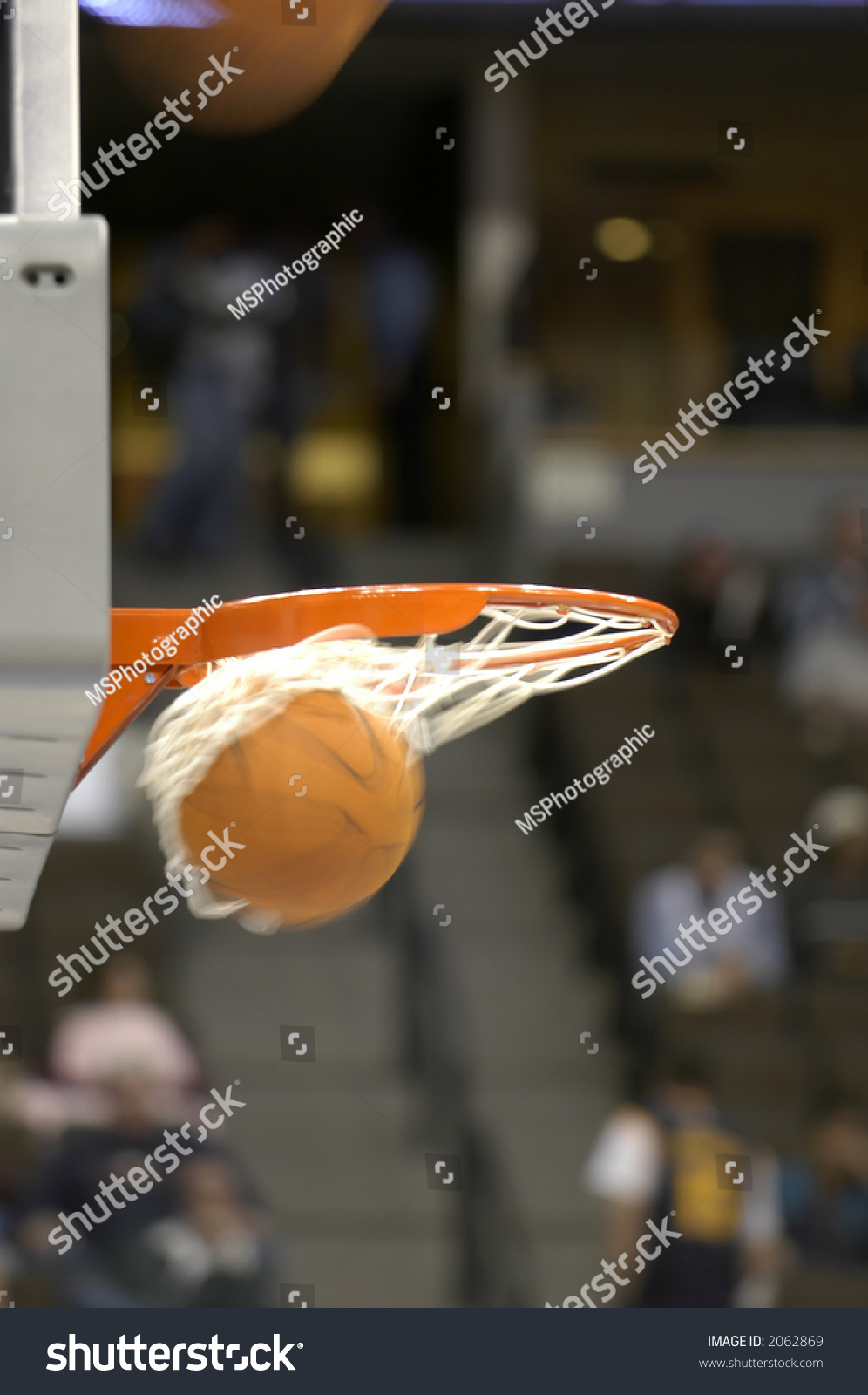 A Basketball Going Through The Net As Another Hits The Backboard Stock