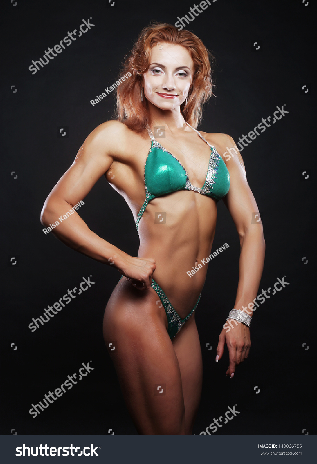 A Beautiful Woman Bodybuilder Posing In Green Bikini Stock Photo Shutterstock