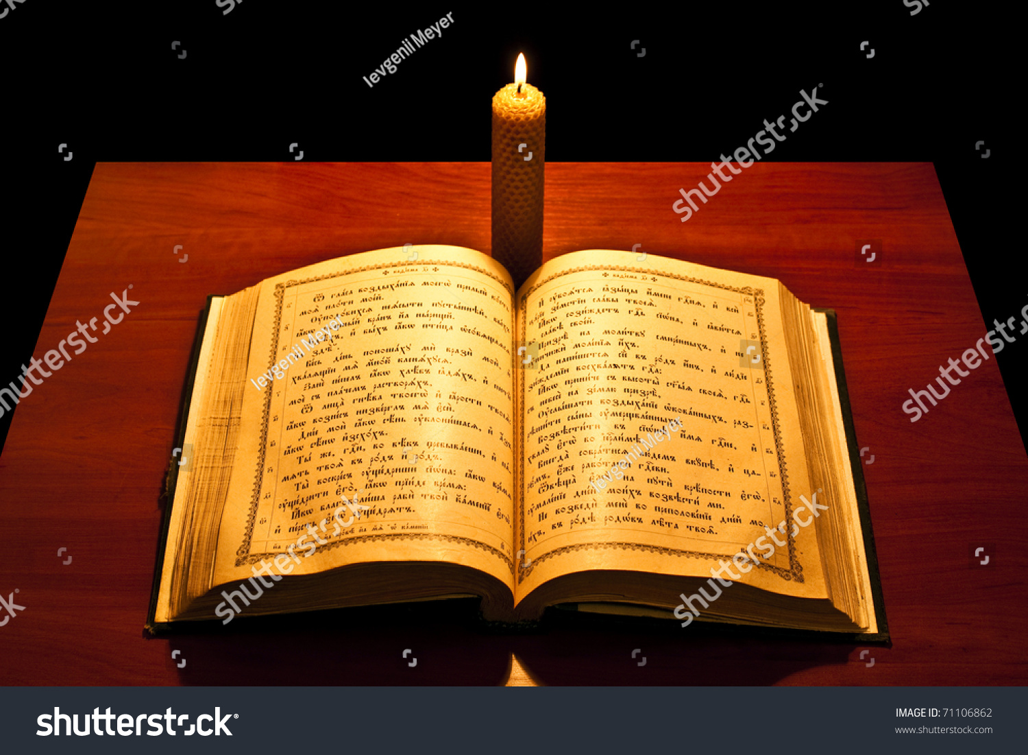 A Bible Open On A Table Next To A Candle Bible Open On Table Next Candle Stock Photo 71106862