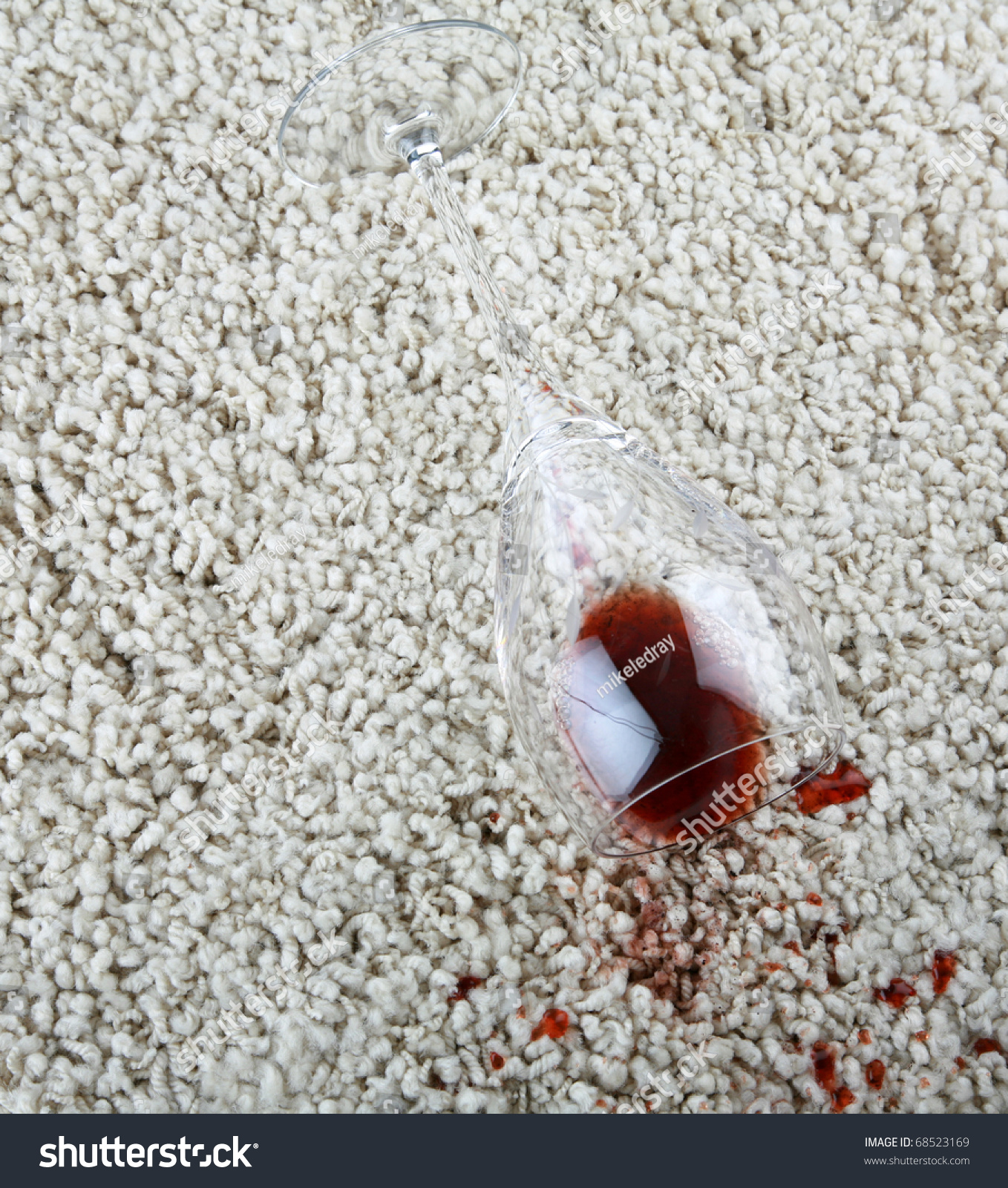 A Cut Crystal Wine Glass Full Of Red Wine Spilled On A Off White Carpet Leaving A Stain Stock