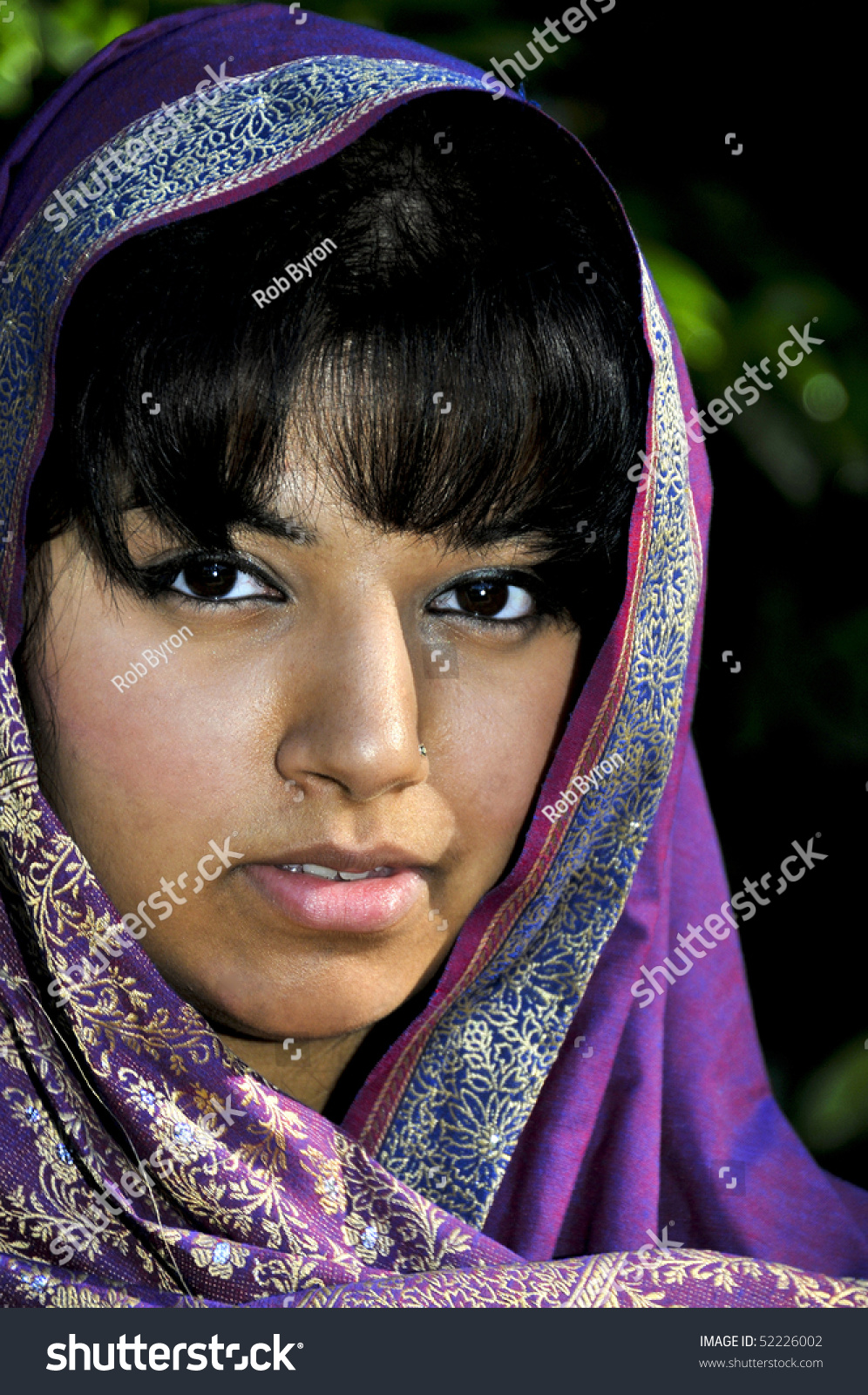 A East Indian Woman Wearing A Traditional Head Scarf Stock Photo