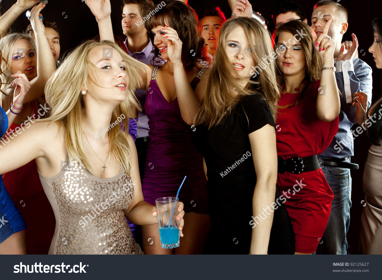 A Group Of Young Beautiful People Dancing At A Disco. Stock Photo 