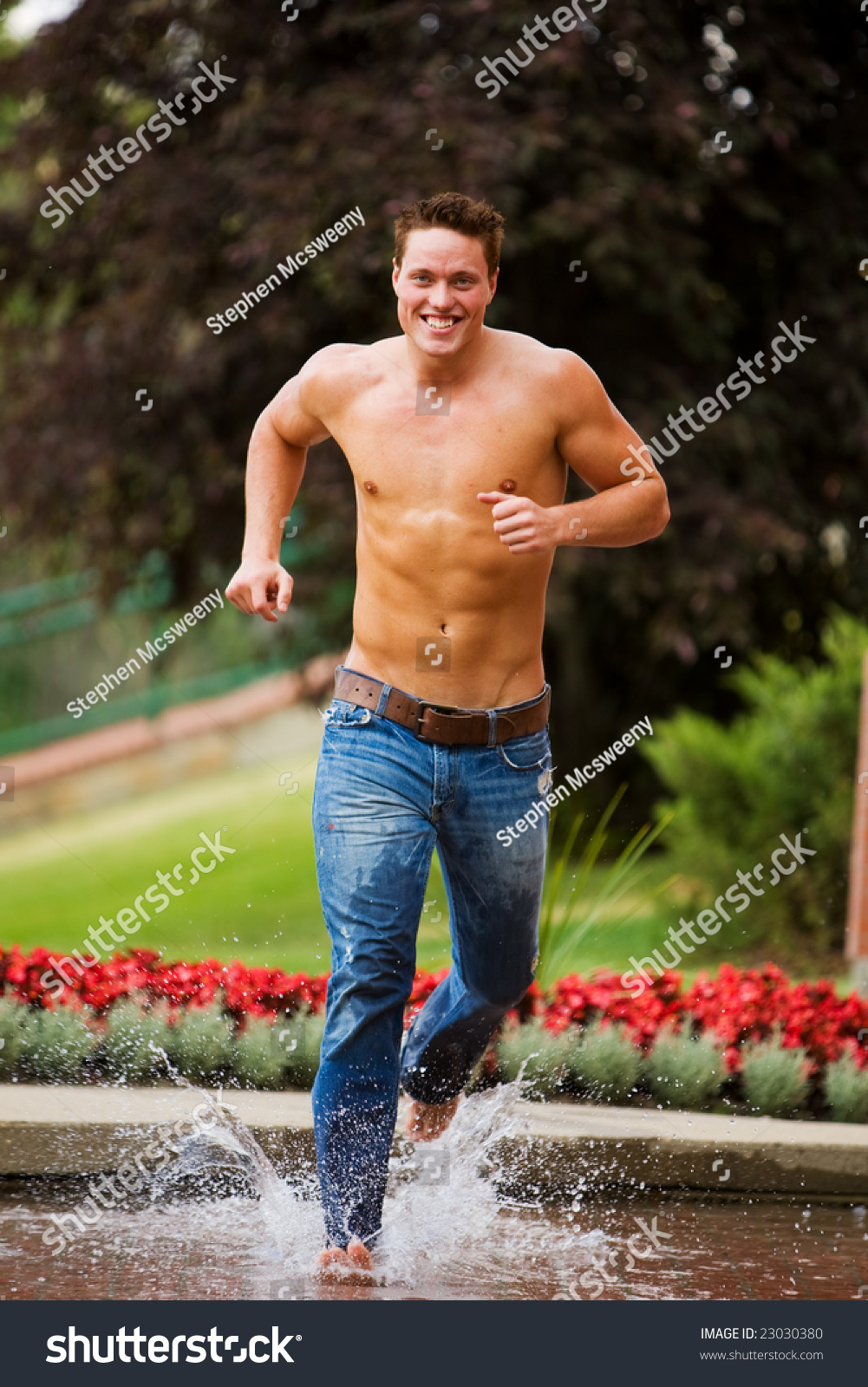 A Muscular Male Model Running Through Water In Summer Stock Photo Shutterstock