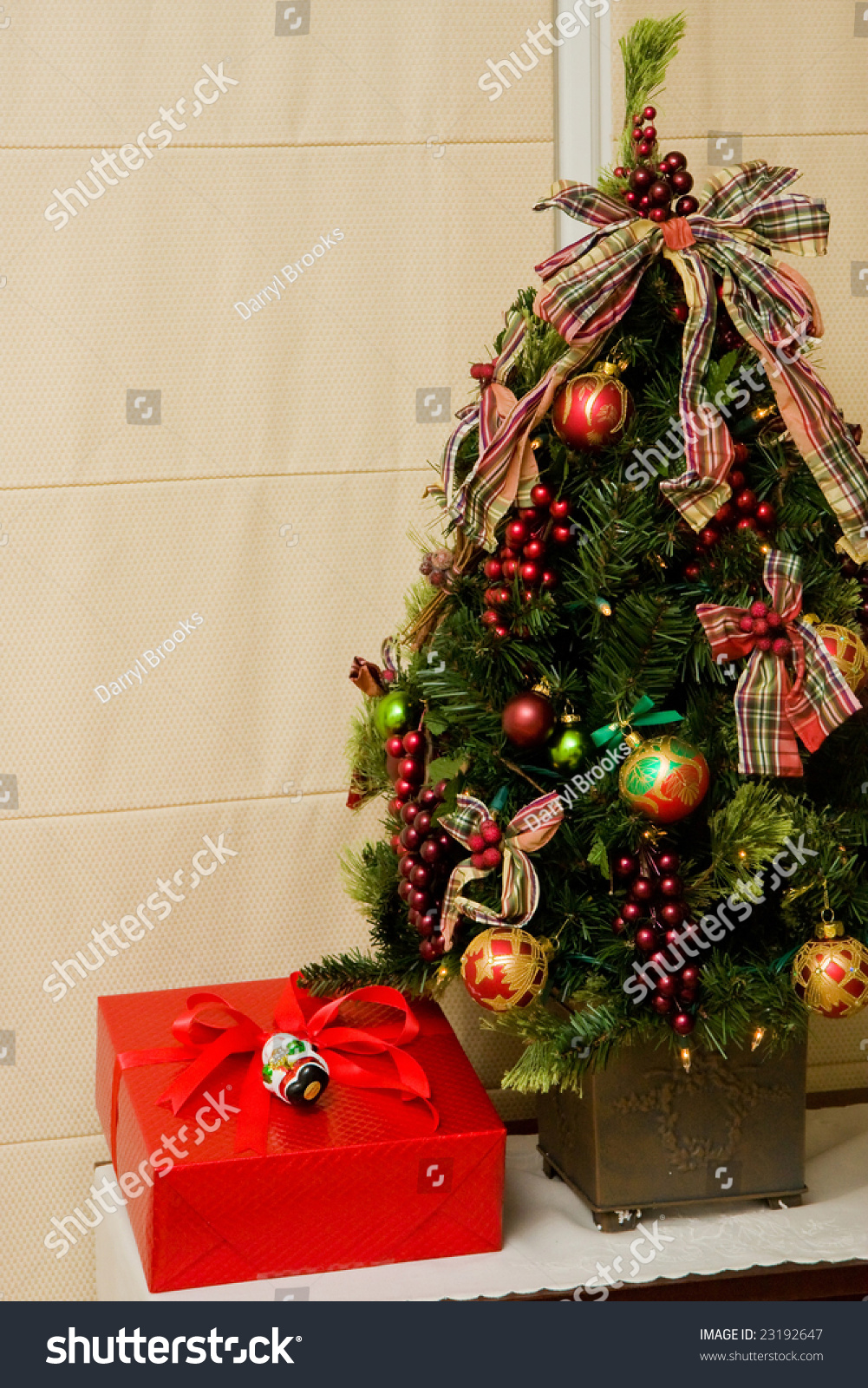 a nicely decorated christmas tree with a red gift a nicely decorated christmas tree with a red gift