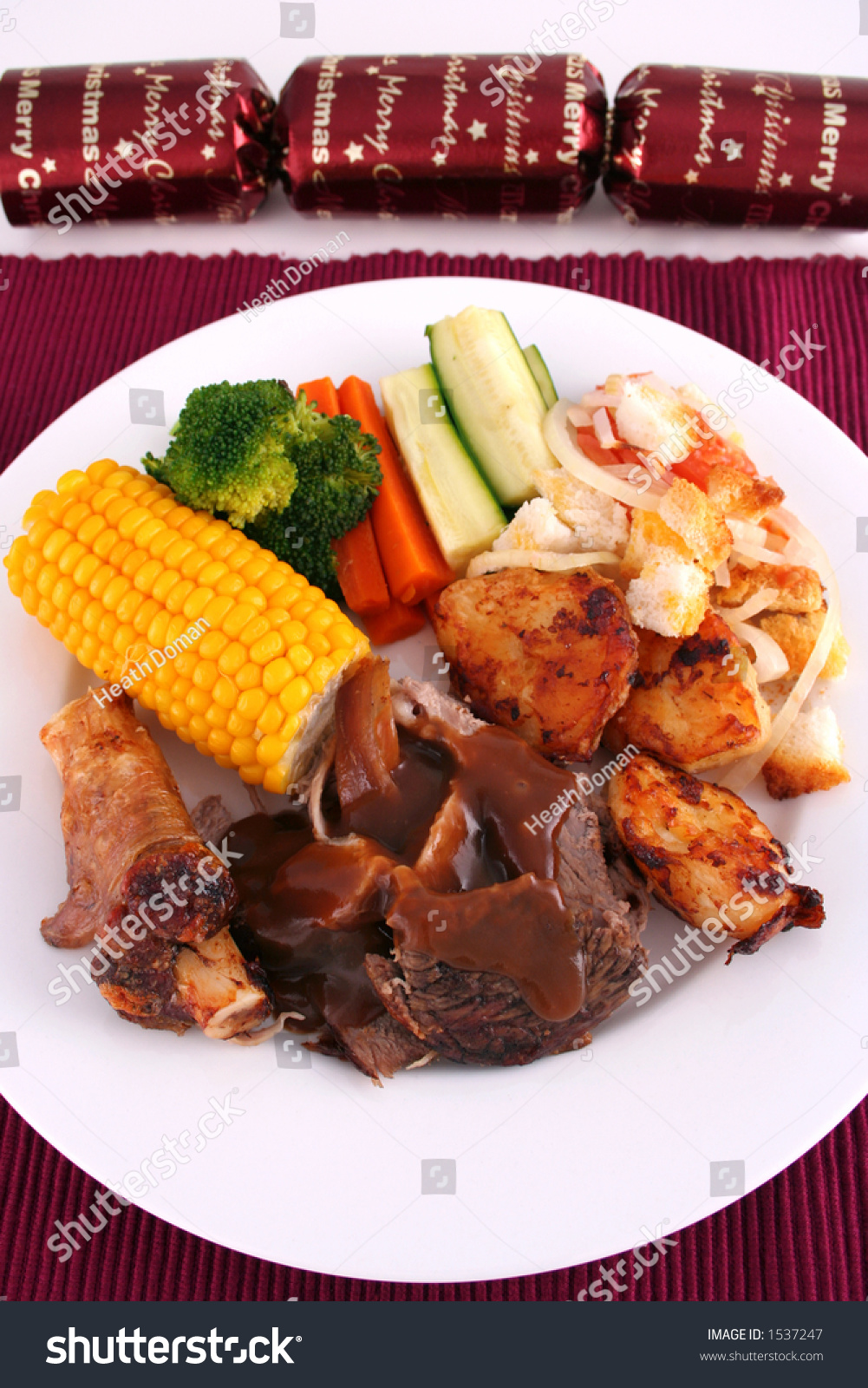 A Roast Lamb Dinner With Vegetables On A White Plate Close Up With ...