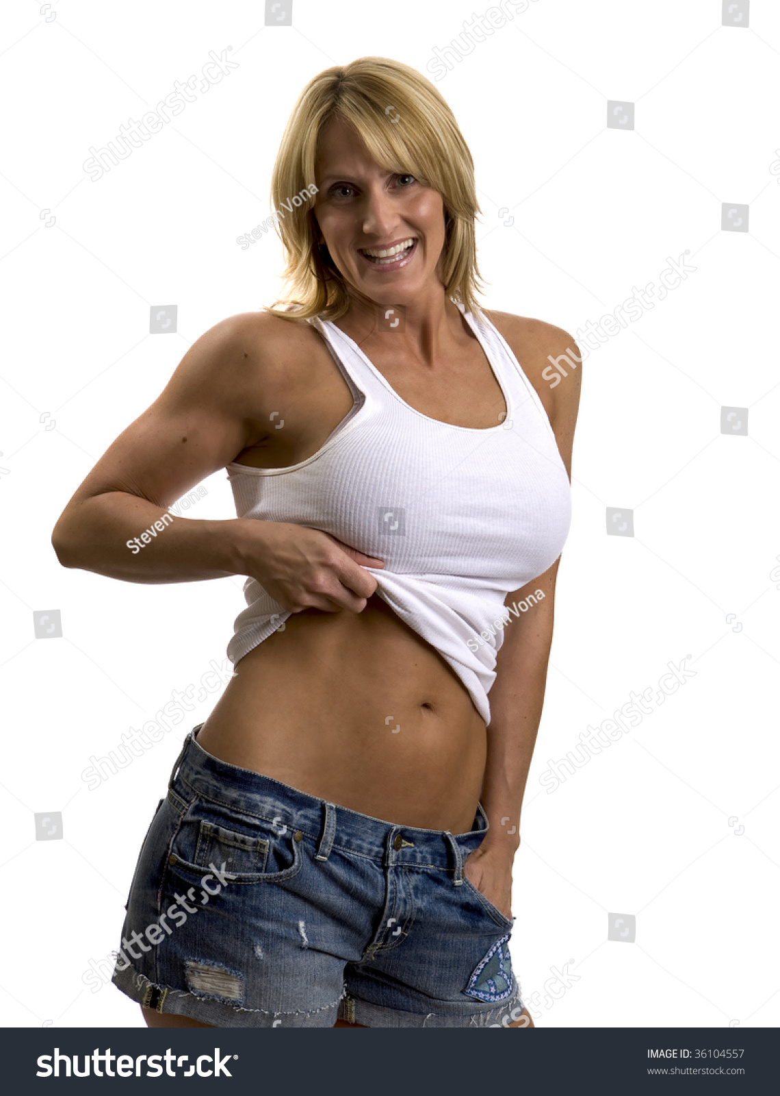 A Very Fit Mature Woman In A Tank Top And Jeans Stock
