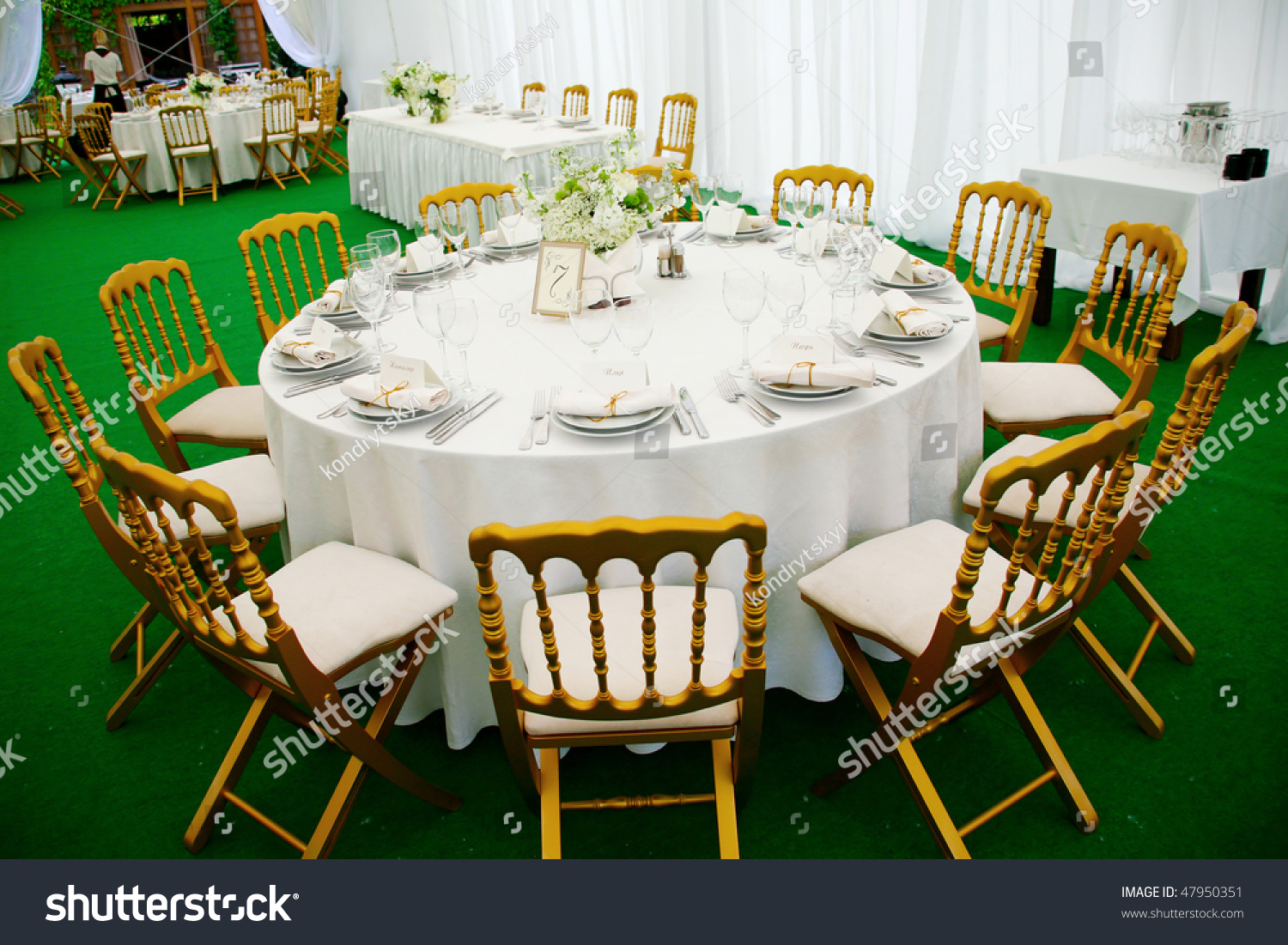 A View Of A Round Banquet Table With Napkins And Silverware Set And A