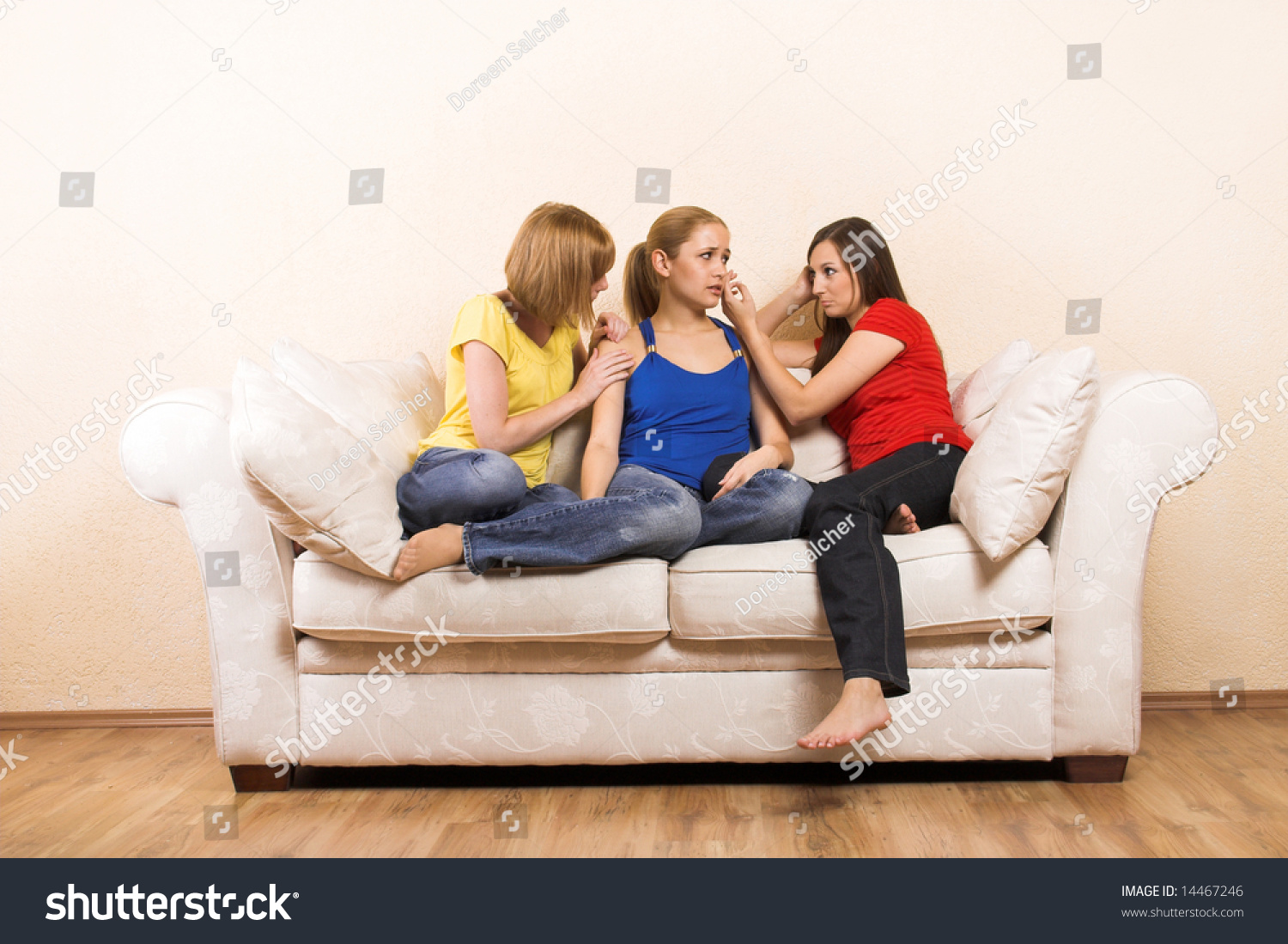 a young woman is having problems and is comfort by her girlfriends a young woman is having problems and is comfort by her girlfriends