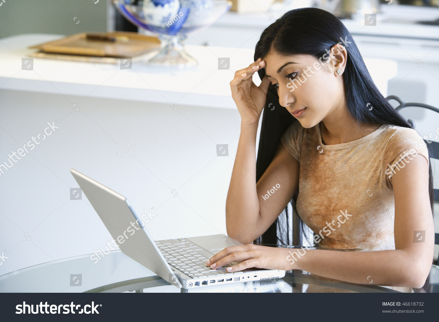 images of worried woman at kitchen table