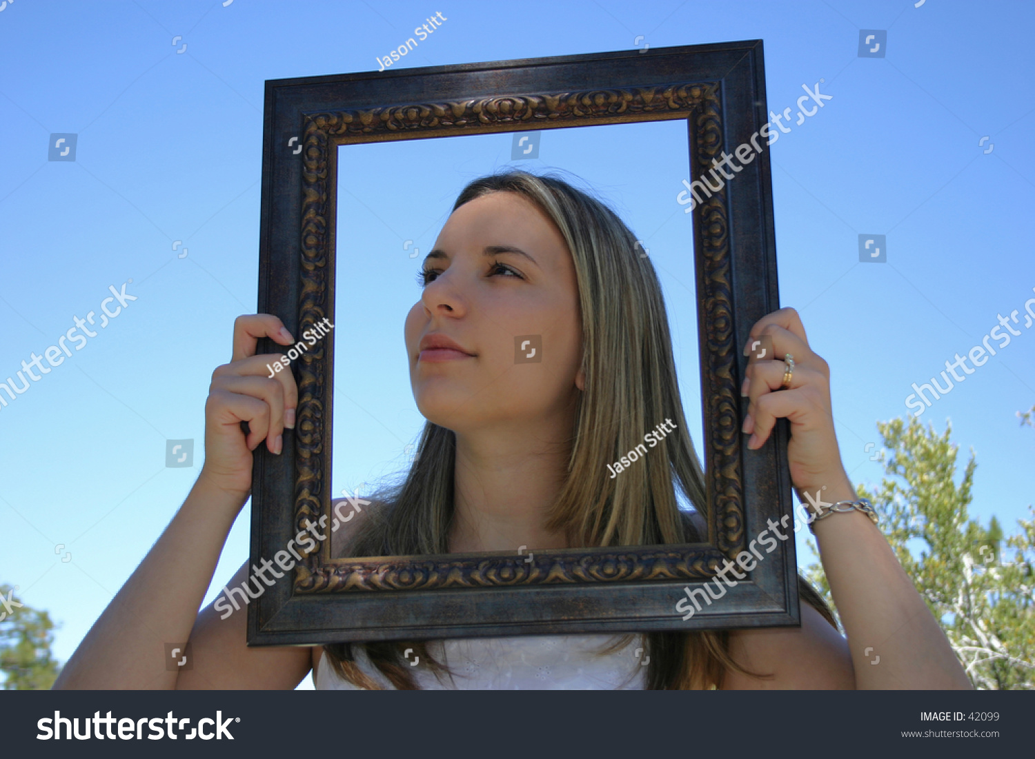 A young woman with her head in a frame A young woman with her head in a frame