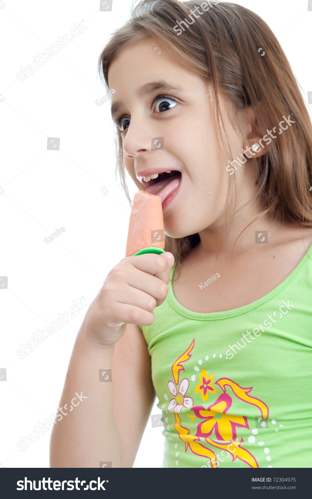 Adorable Girl Licking An Popsicle With A Funny Face Isolated On A White ... photo