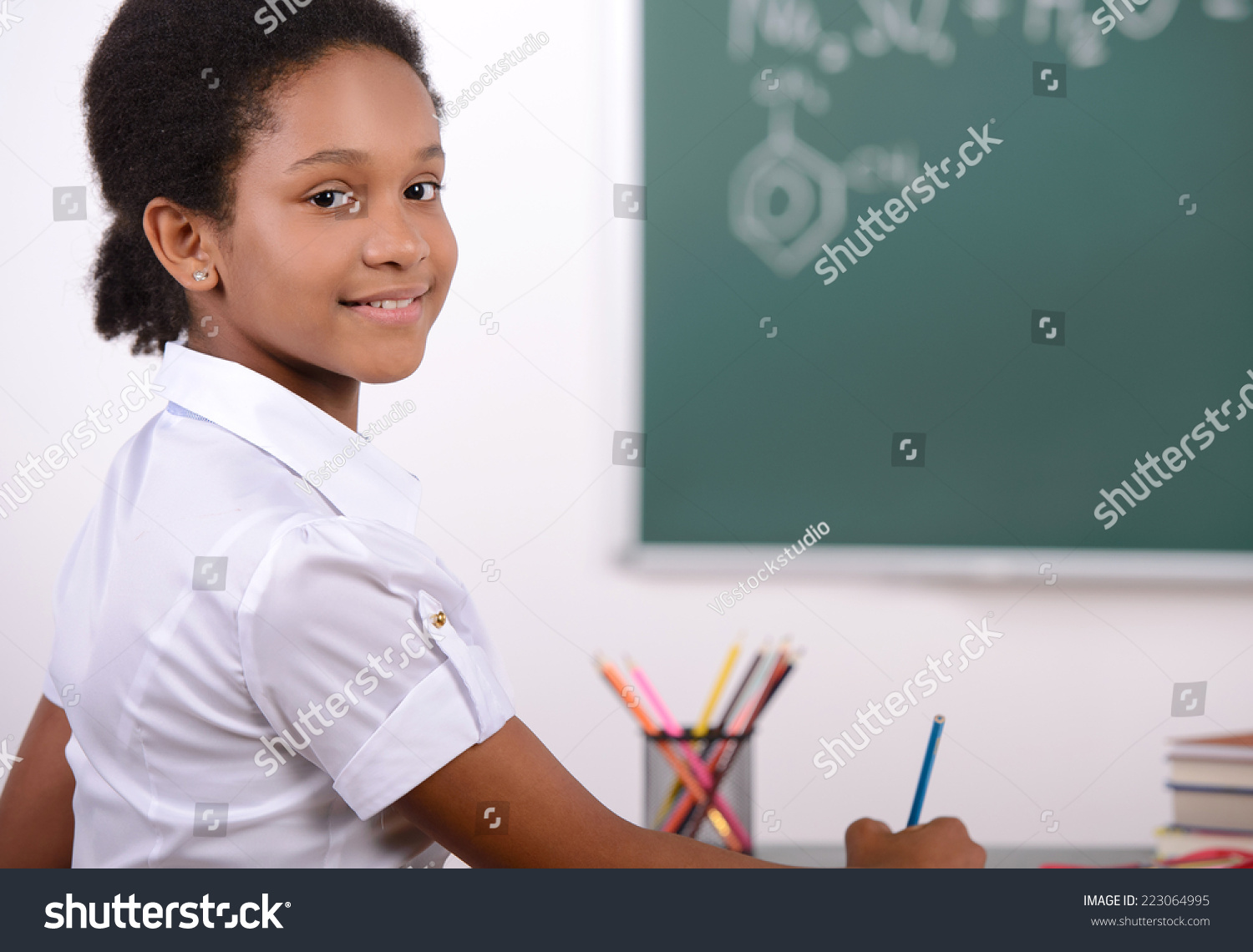 african-american-student-doing-math-problems-on-the-chalkboard-stock-photo-223064995-shutterstock
