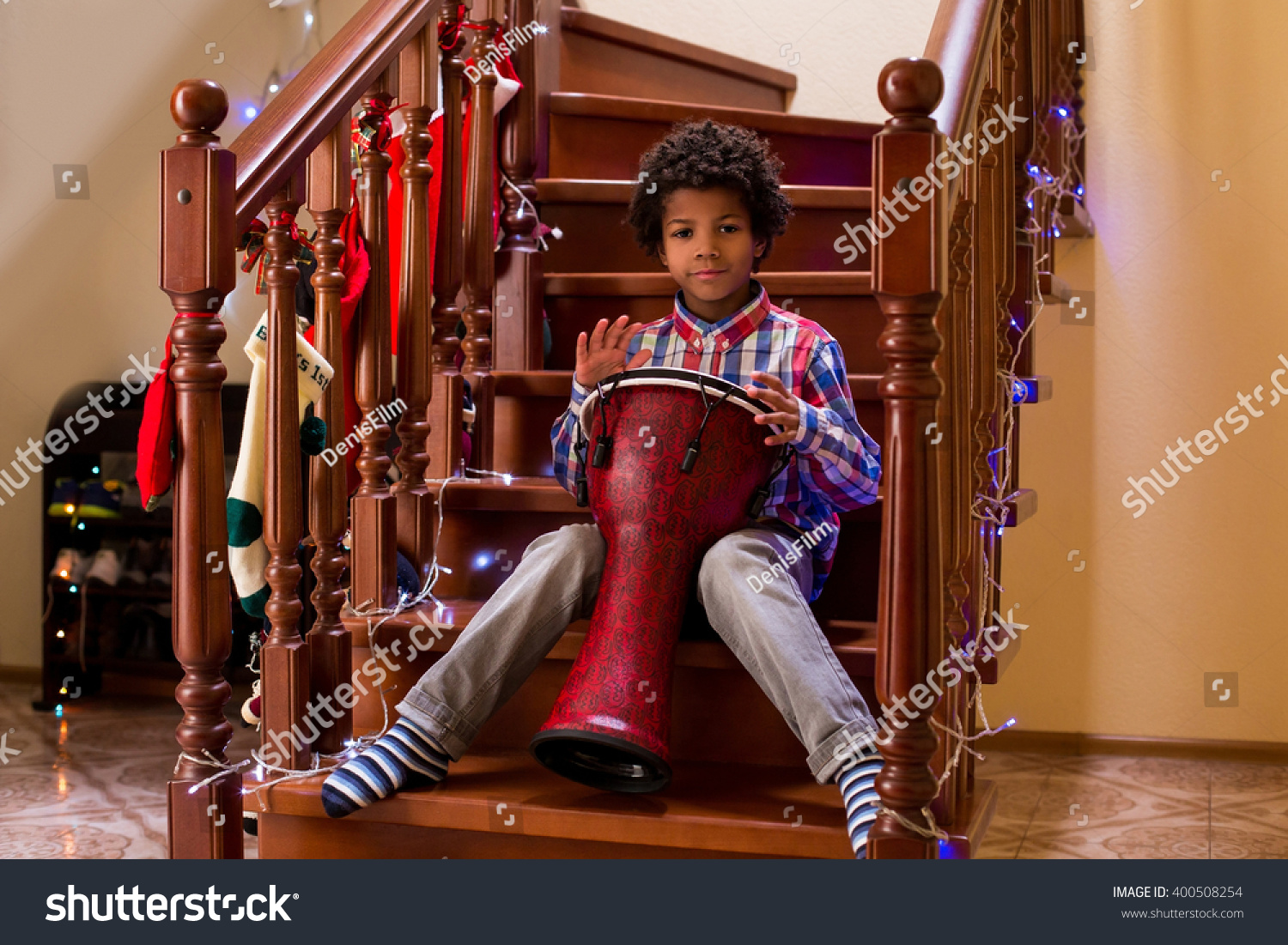 Afro child plays on drum Kid with drum on Christmas Young percussion talent Call it his first concert Afro child plays on drum Kid with drum on Christmas Young percussion talent Call it his first concert