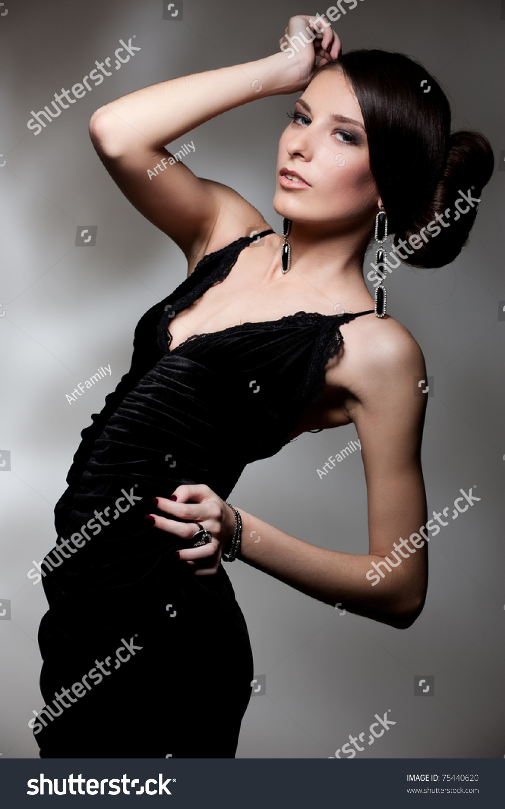 Alluring Woman In Black Dress Posing Over Dark Background Stock Photo ...