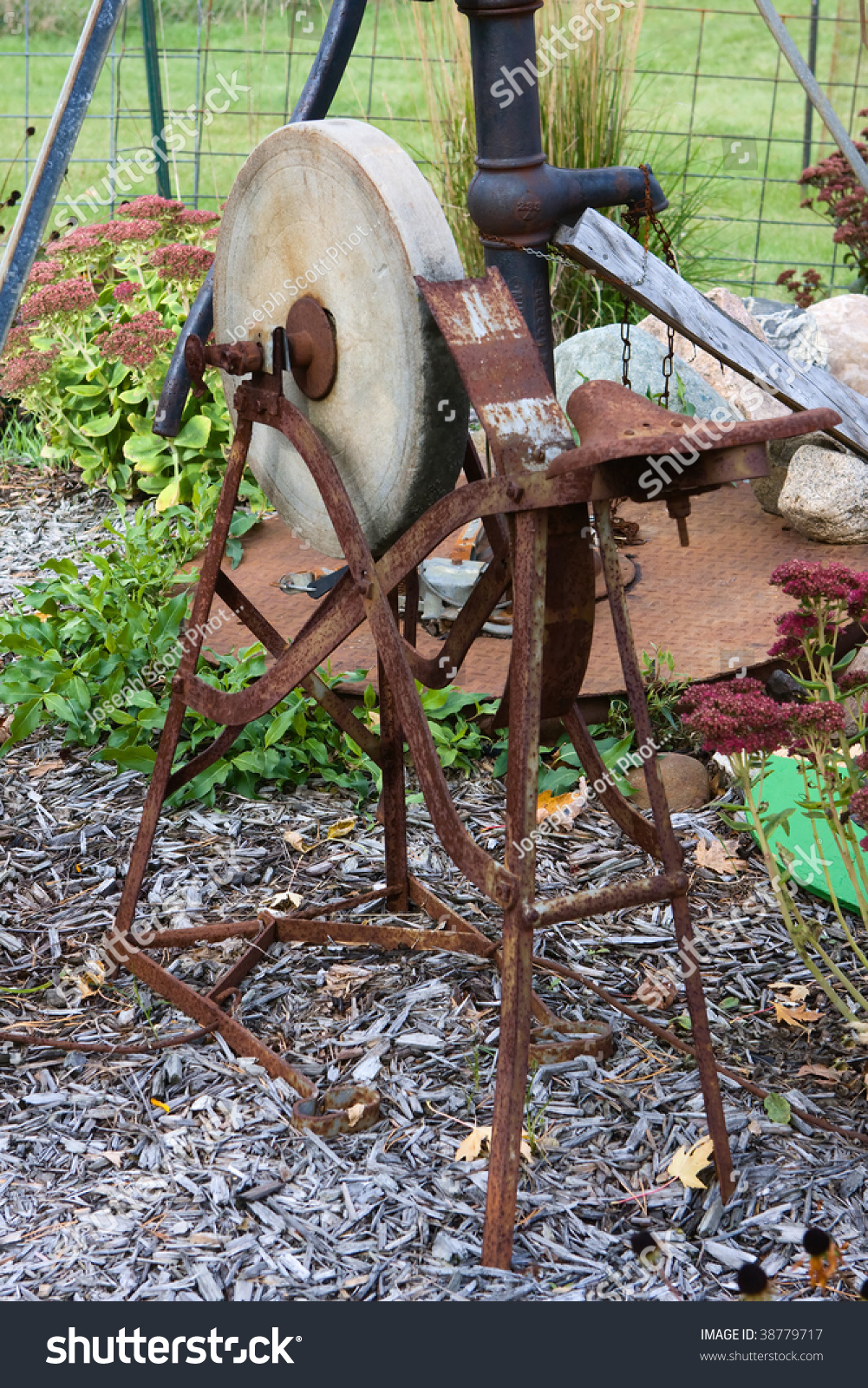 http://image.shutterstock.com/z/stock-photo-an-antique-sit-down-grinding-wheel-sharpening-stone-38779717.jpg