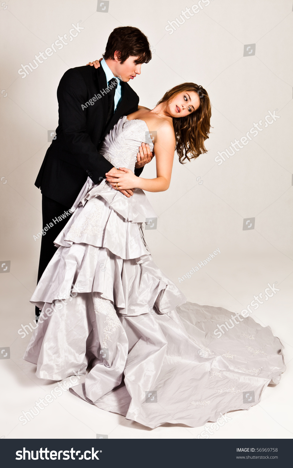 An Attractive Young Couple In The Midst Of A Dance Move Are Dressed In Formal Attire Vertical 