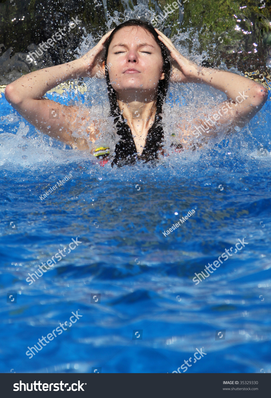 An Attractive Young Woman Taking A Shower Under An Artificial Waterfall