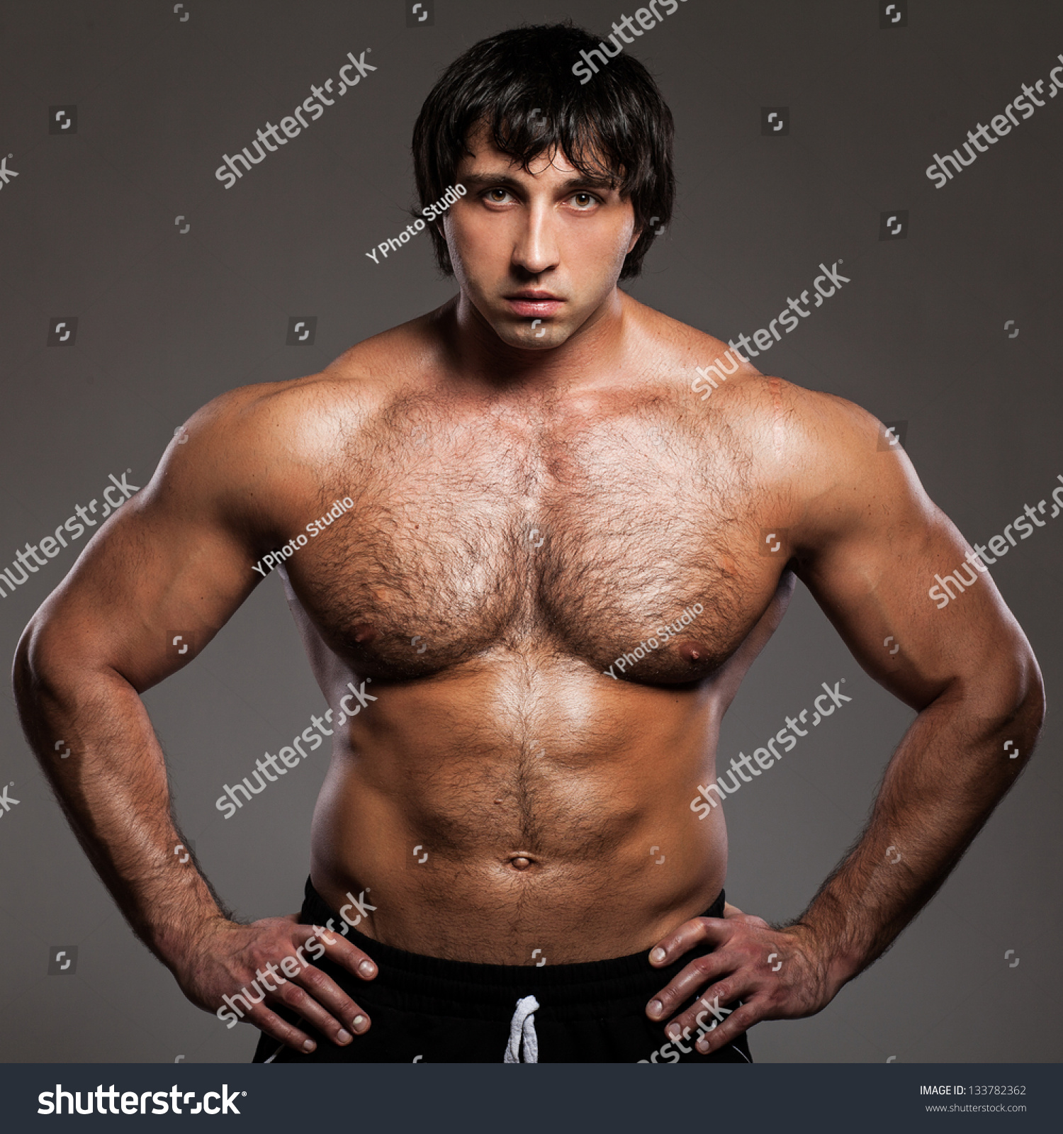 Handsome, Muscular Young Man Shirtless Leaning Against 