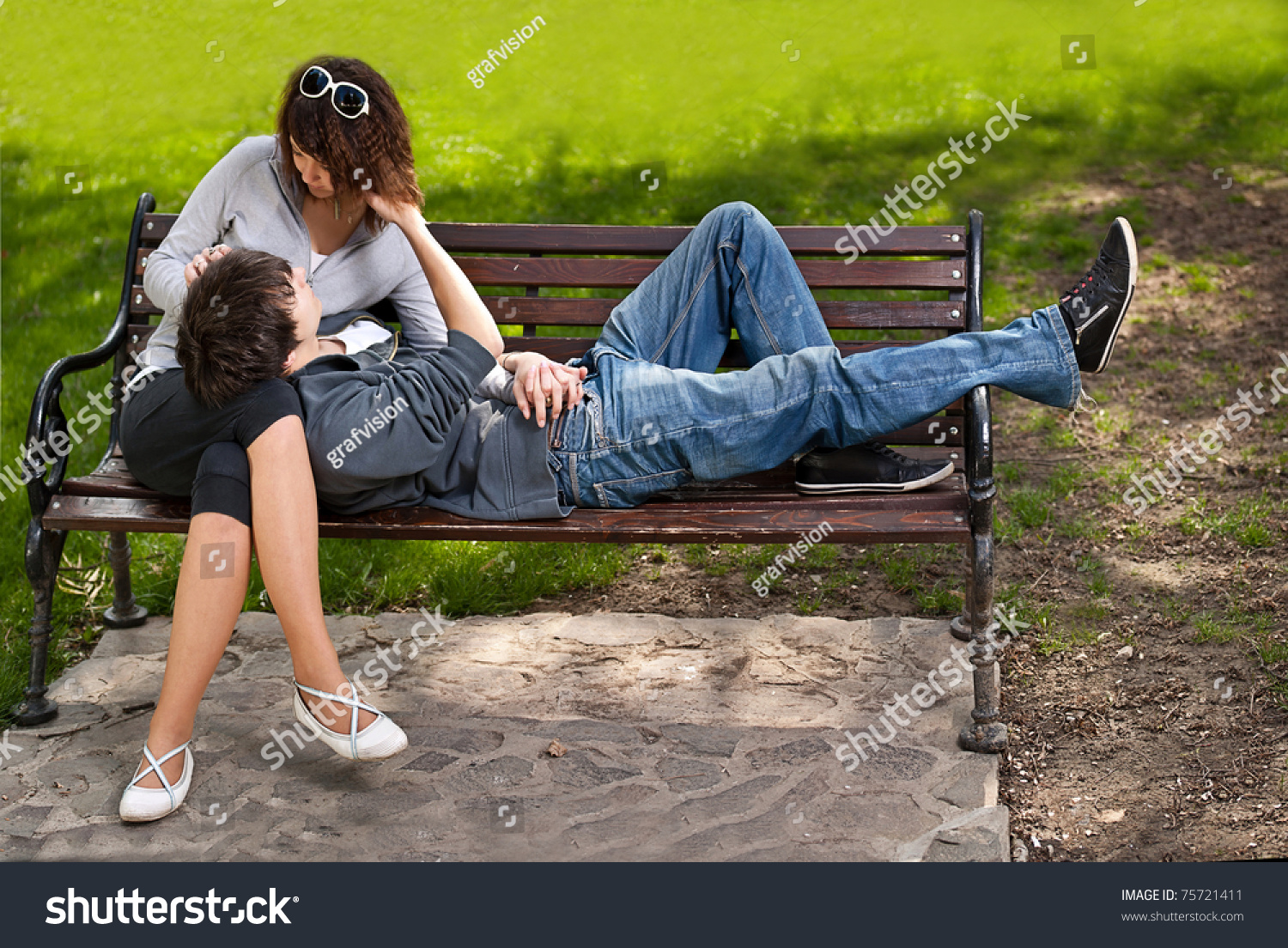 Attractive Couple Sitting On Bench In The Park Stock Photo 75721411 ...