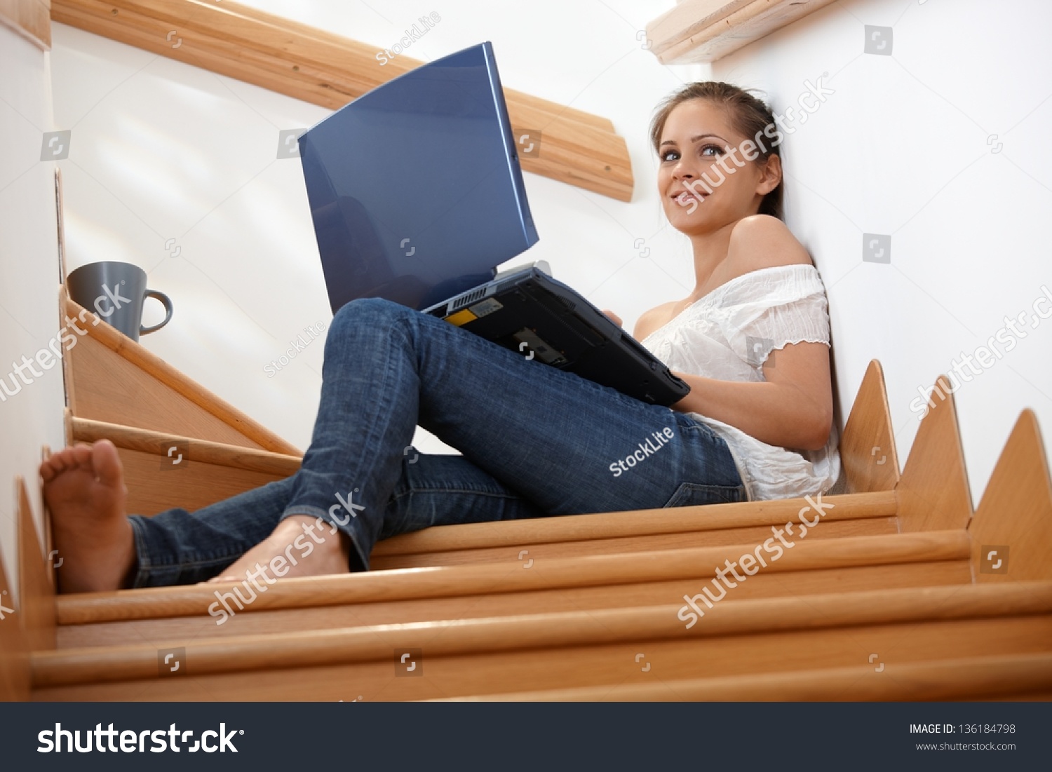 Woman Using Laptop Computer While Sitting In Sofa Stock 