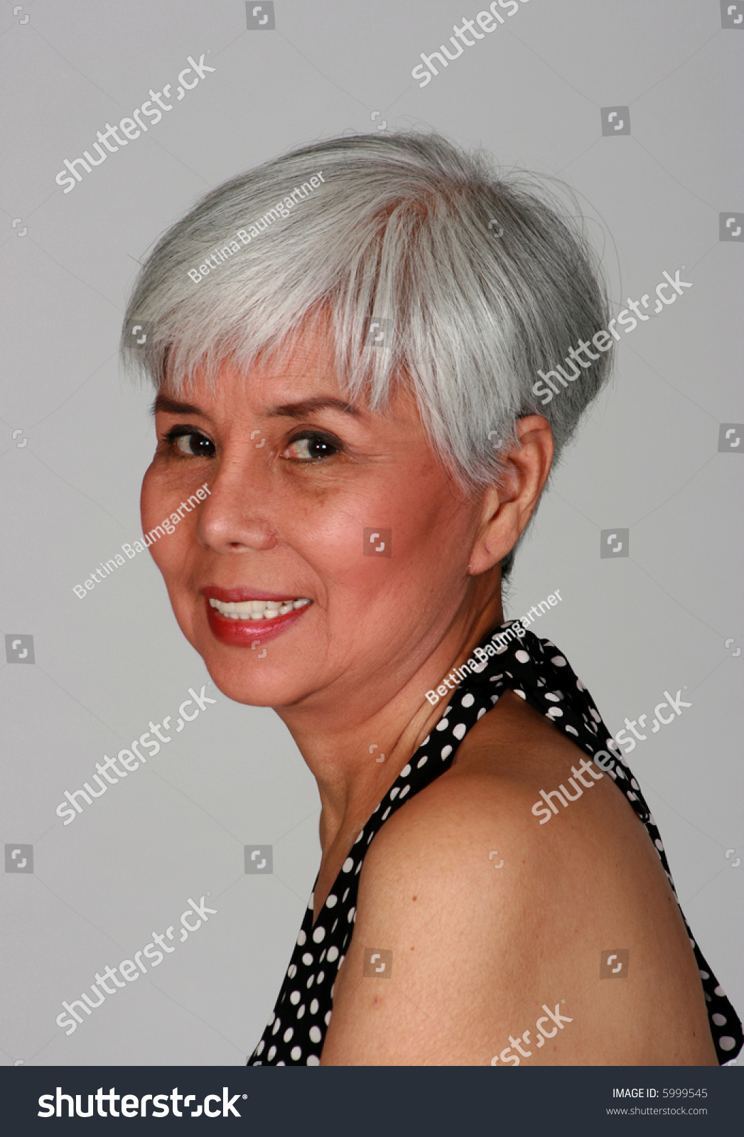 Attractive Mature Woman Wearing A Summer Dress With Polka Dots Stock