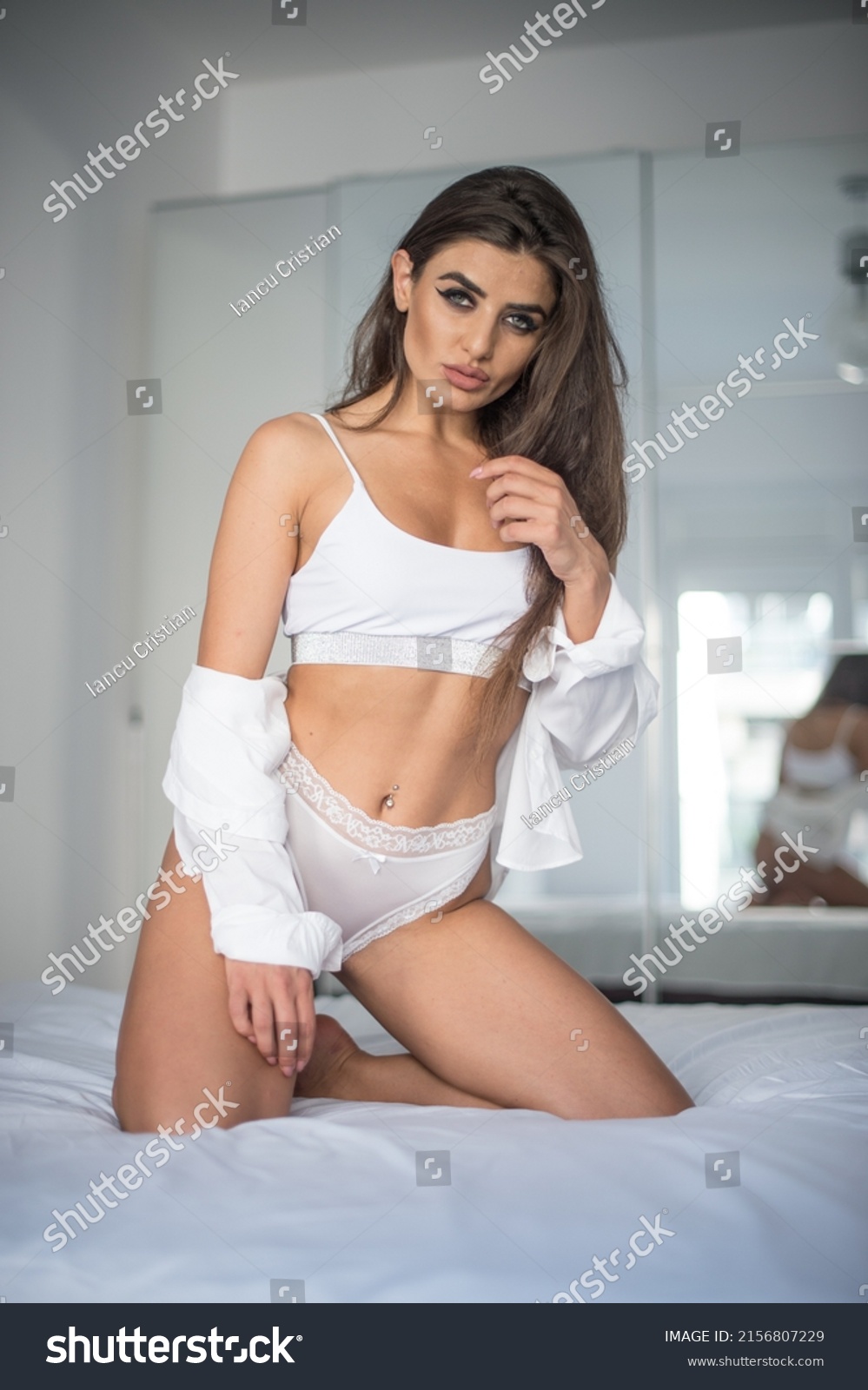 Attractive Sexy Brunette White Lingerie Posing Stock Photo