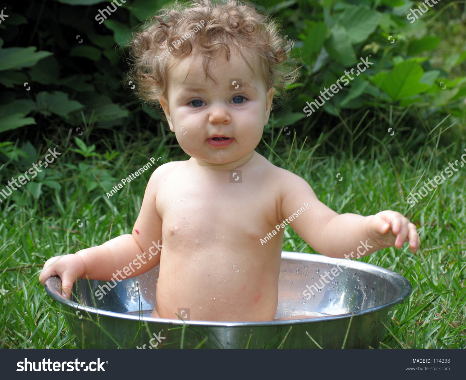 Baby Bathing In A Basin Of Water On A Summer Day Stock Photo 174238