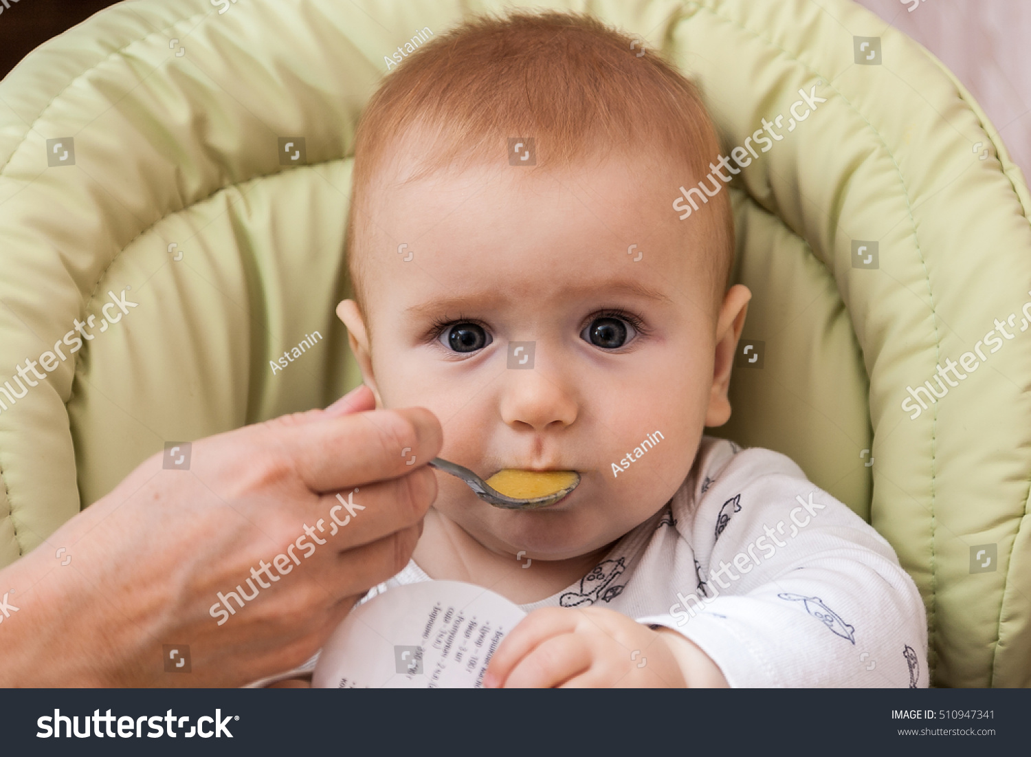 Baby Boy Eating With Spoon At Home In Highchair Baby Eating Food