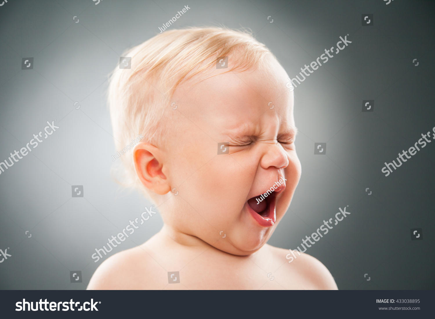 baby-with-squint-eyes-and-open-mouth-stock-photo-433038895-shutterstock