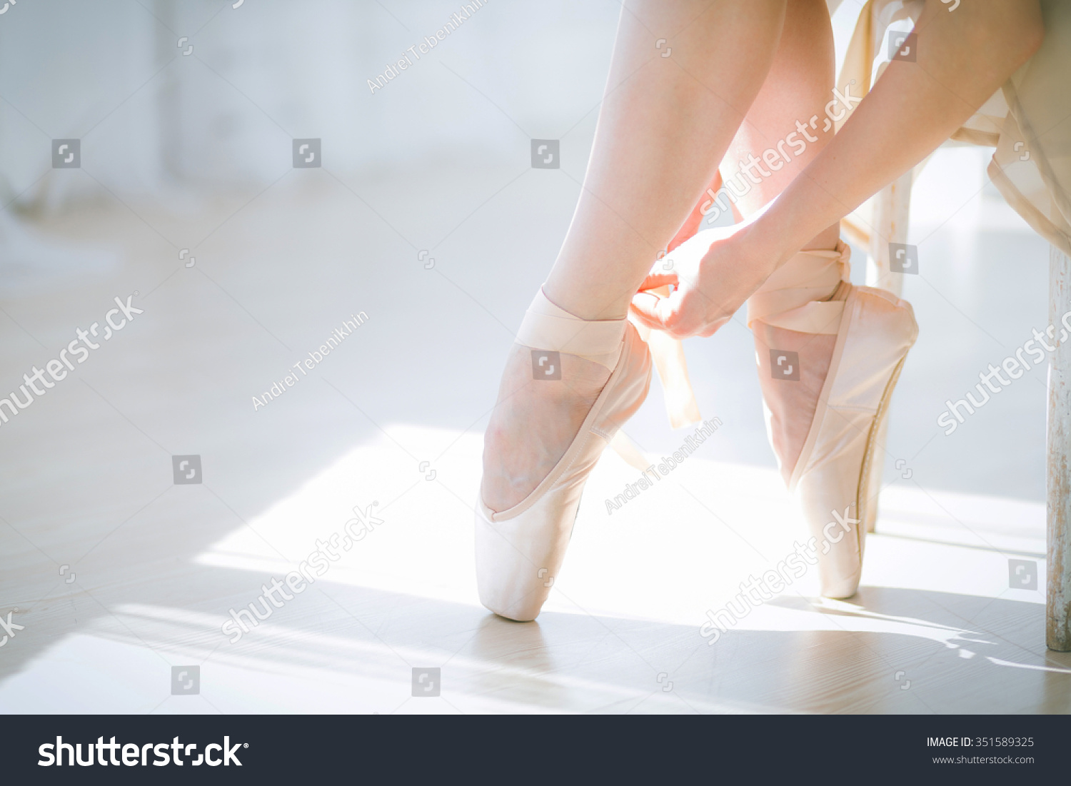 ballerina-tying-pointe-ballet-shoes-stock-photo-351589325-shutterstock