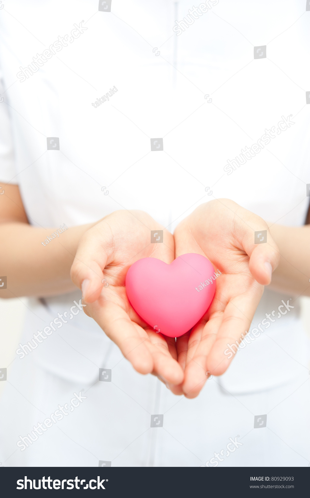 Senior Female Nurse Holding Red Heart With Love Stock 