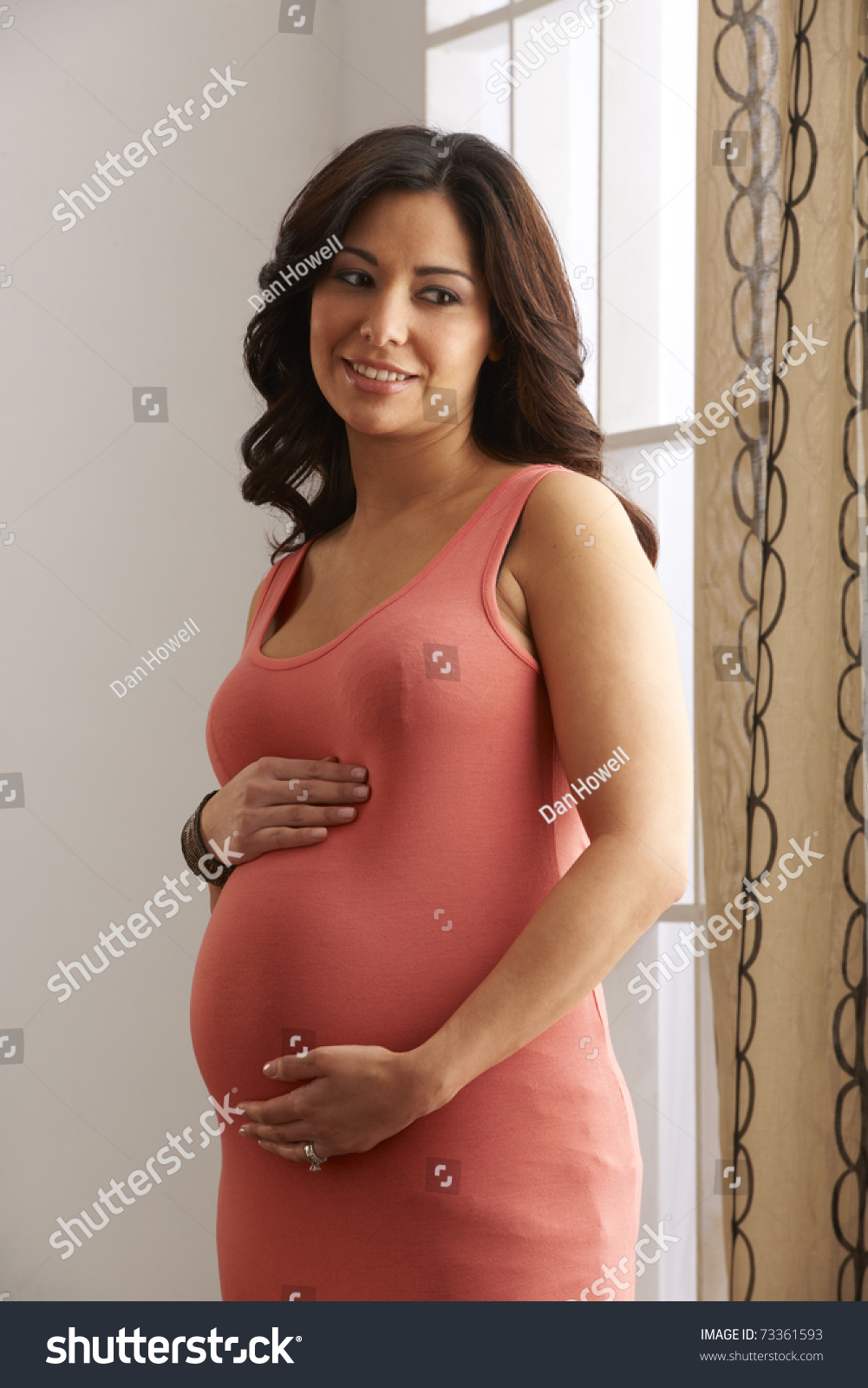 Beautiful Expecting Mother At Six Months Pregnant Holding Belly In