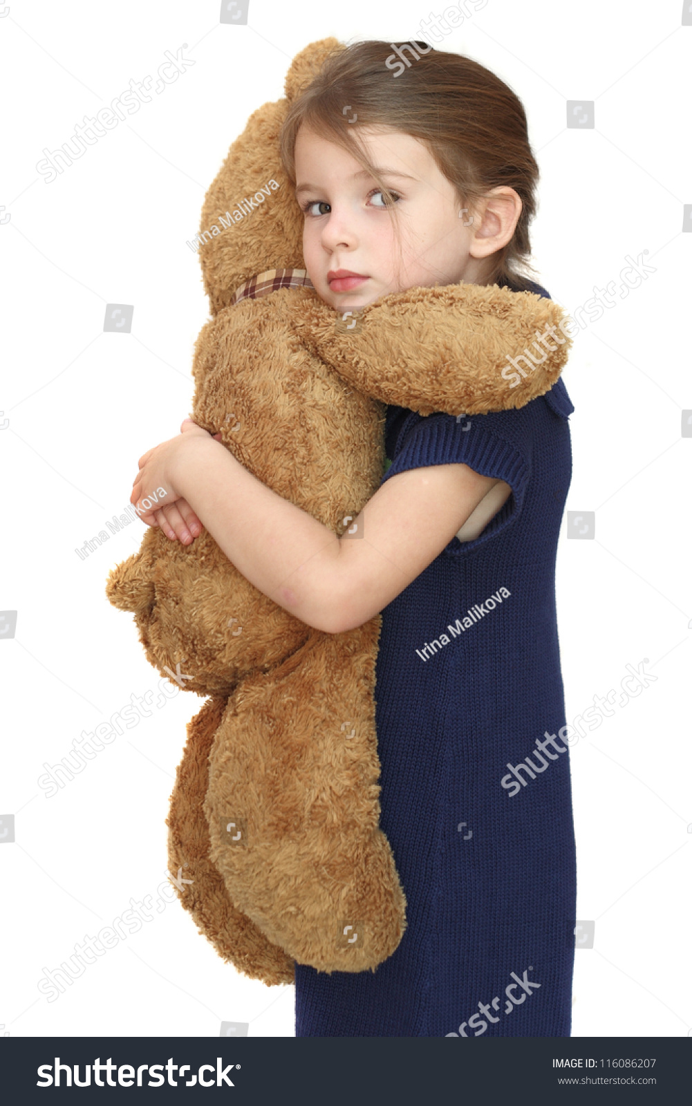 girl hugging a teddy bear