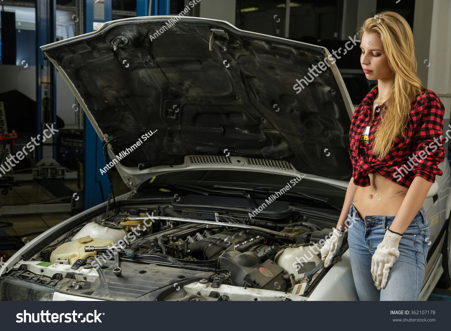 Beautiful Girl Mechanic Repairing A Car Stock Photo