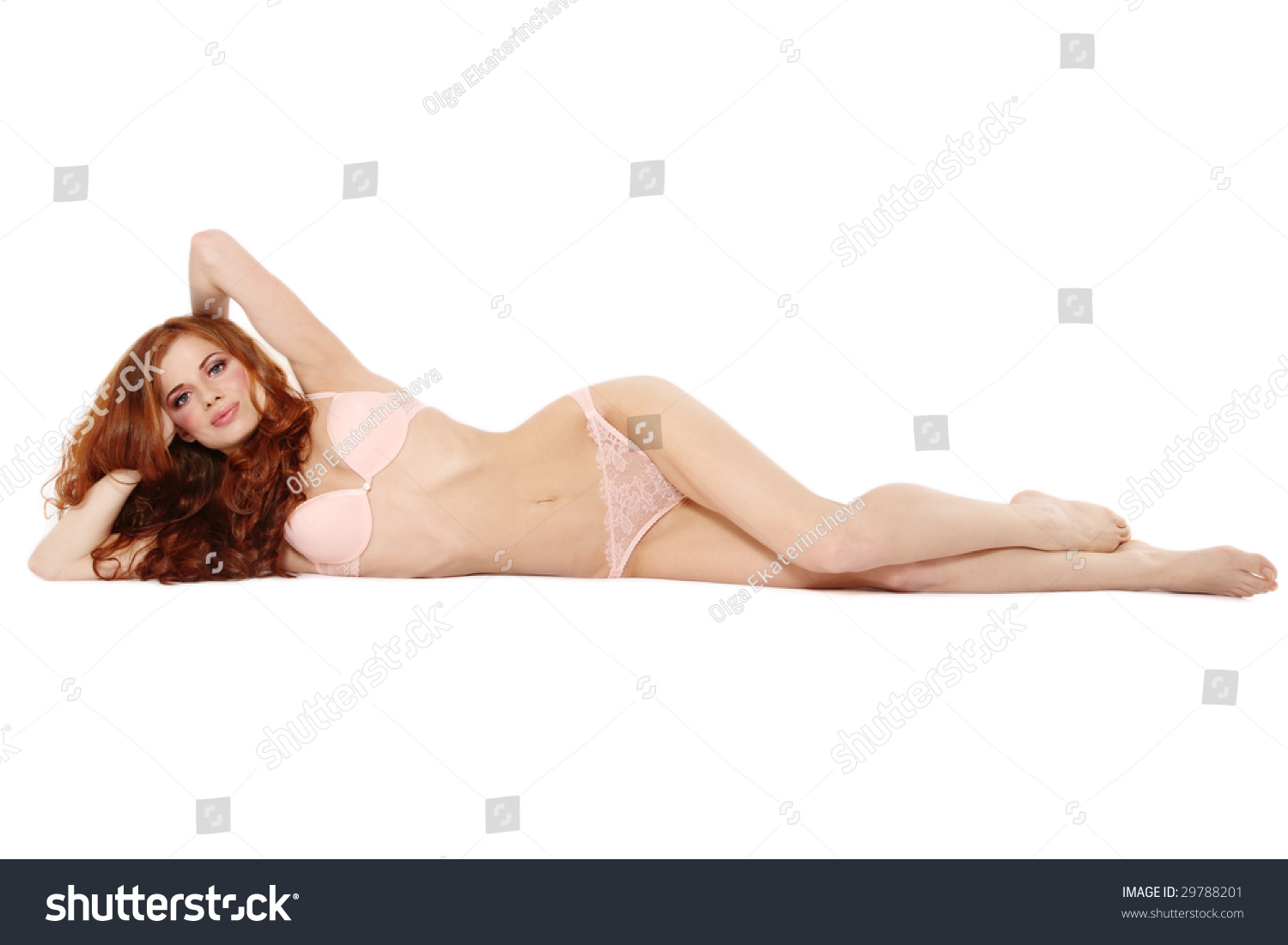 Beautiful Sexy Slim Redhead Girl In Pink Lingerie Lying On White
