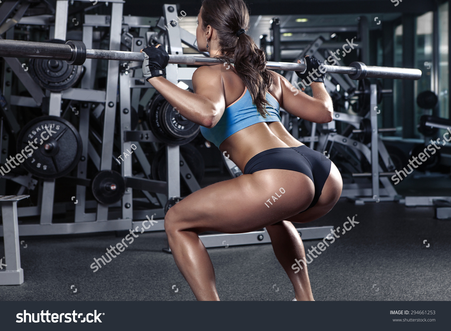 Beautiful Sporty Sexy Woman Doing Squat Workout In Gym Stock Photo