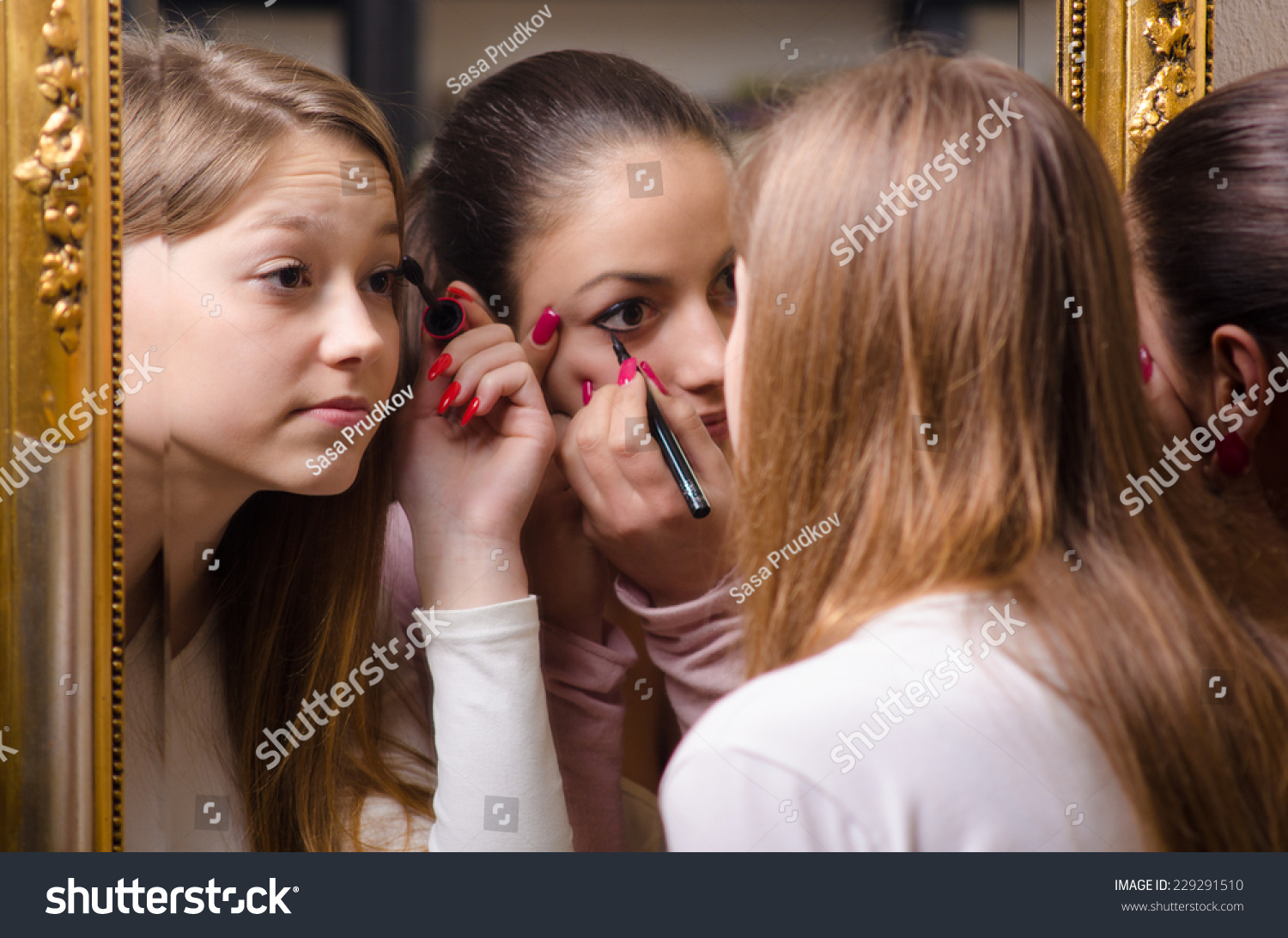 Beautiful Teenage Girlfriends Having Fun While Putting Make Up In Front 