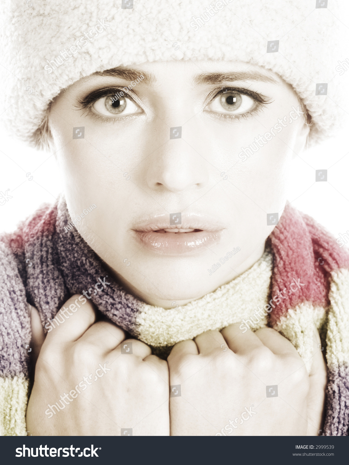 Beautiful Woman Bundled Up In A Winter Hat And Scarf Isolated On A