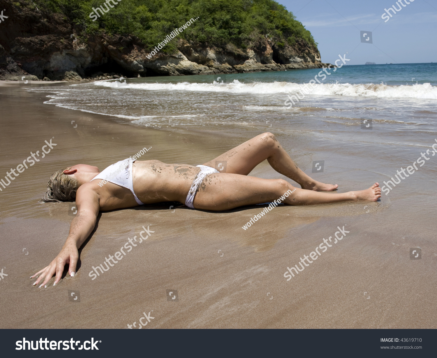 Beautiful Woman In White Bikini Covered In Sand Relaxing On Costa Rican