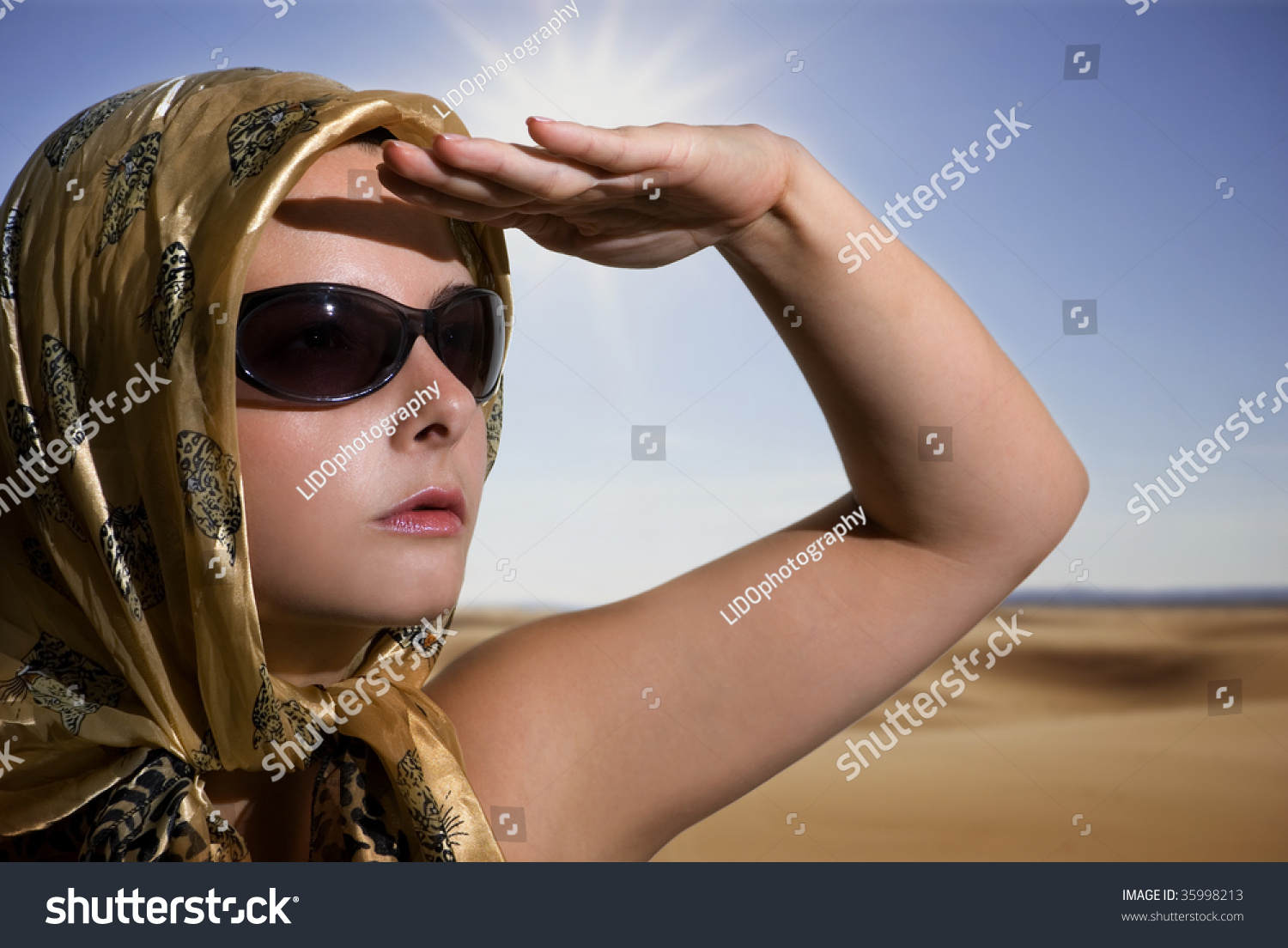 Beautiful Woman Wearing Sunglasses Head Covered With Scarf Over A